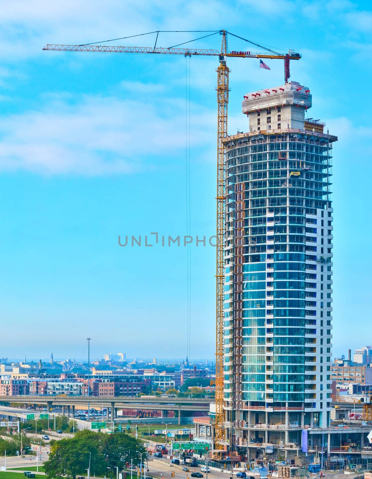 Daytime aerial view of skyscraper construction in Milwaukee, Wisconsin, showcasing urban development and modern architecture, captured with DJI Mavic 3 drone.