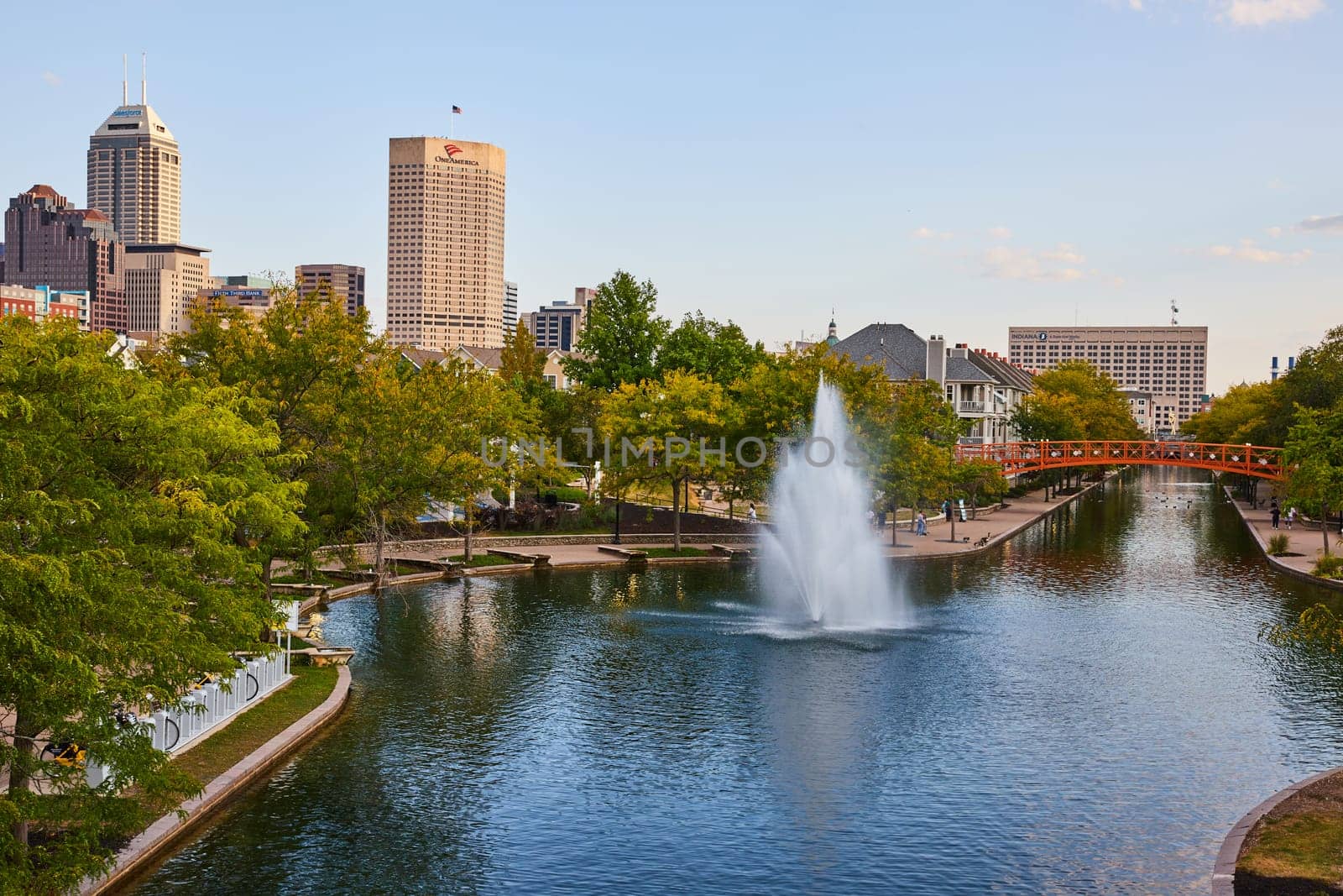 Serene Urban Park with Fountain Against Downtown Indianapolis Skyline, Capturing Balance of Nature and City Life in Golden Hour, 2023