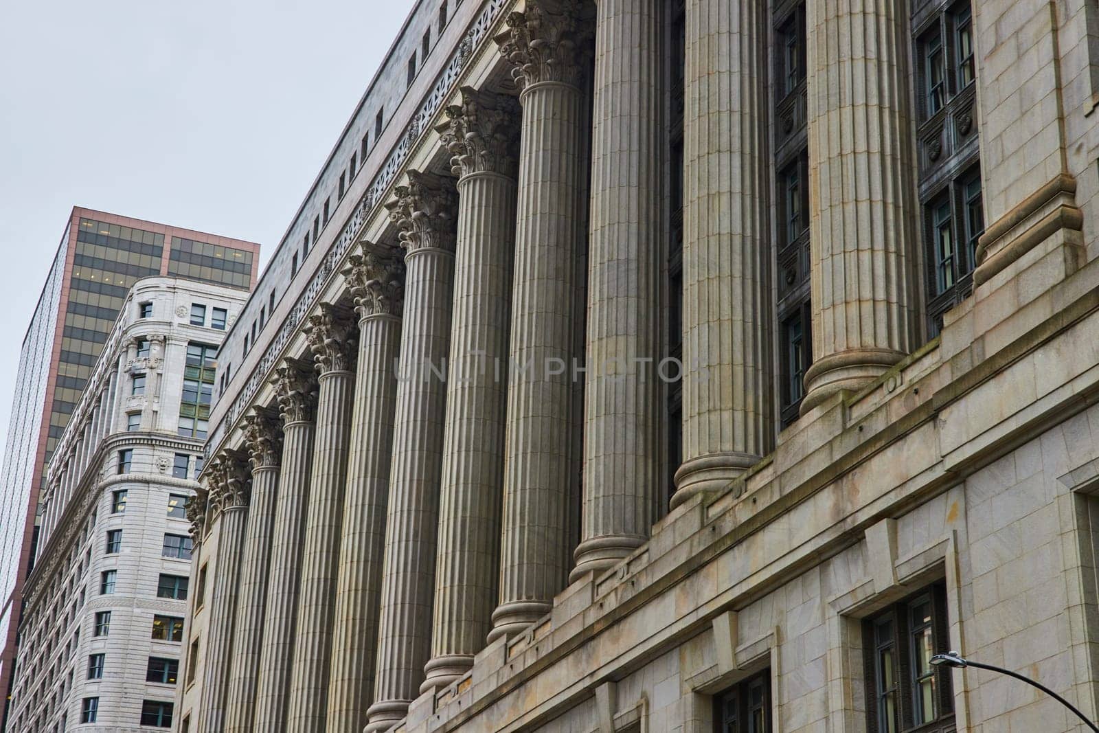 Grey building with pillars and columns on overcast day with gloomy, ominous sky, Chicago, IL by njproductions
