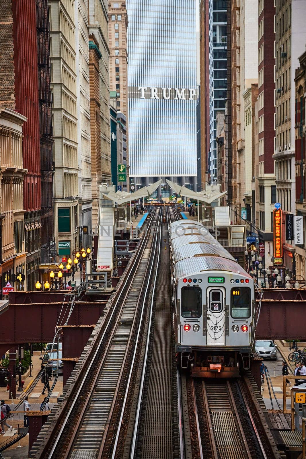 Elevated train in motion amidst Chicago's towering architecture, featuring Trump Tower, in 2023