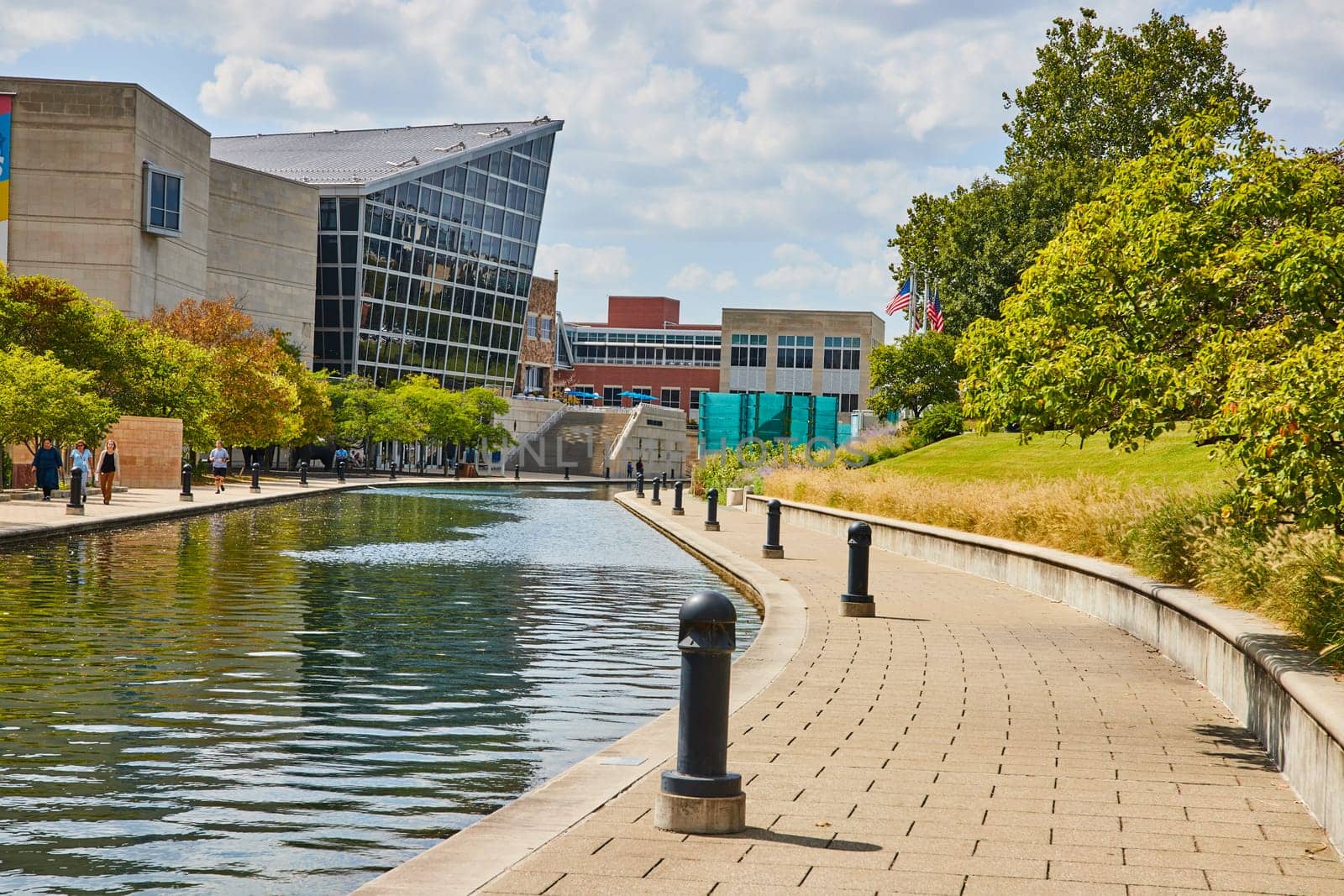 Serene Daytime Scene at Indianapolis Urban Waterfront Promenade, Featuring Modern Architecture and Leisure Activity, 2023