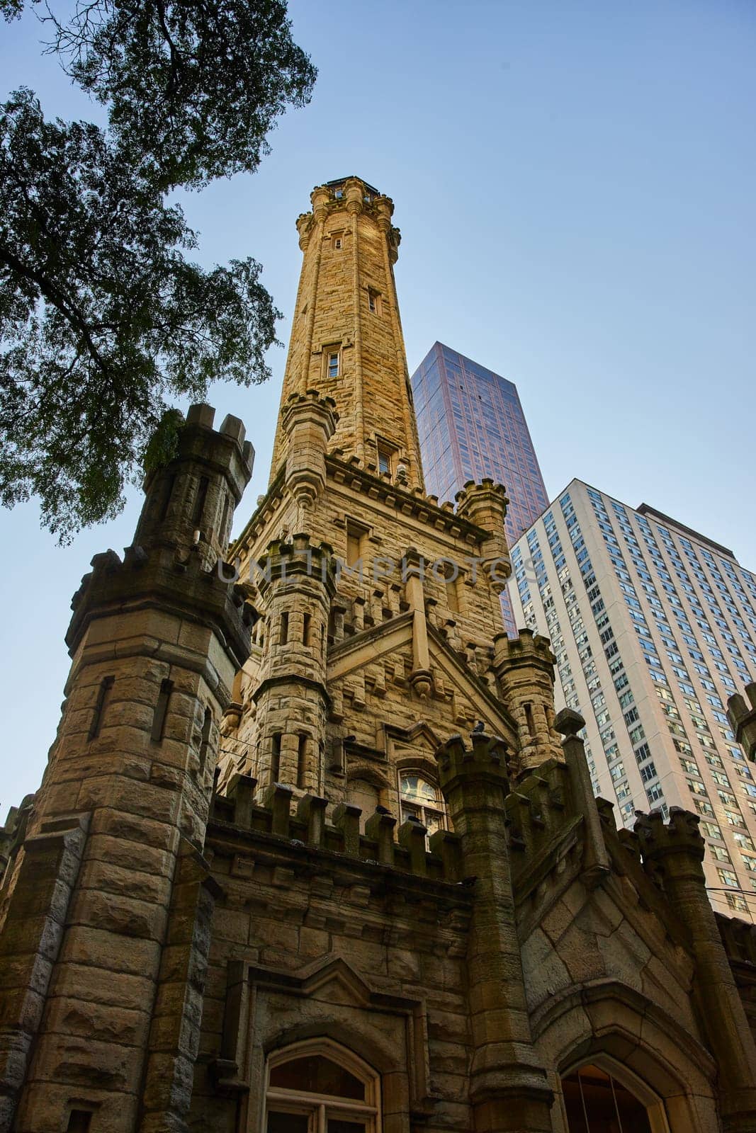 Upward view of old Chicago water tower with historic architecture building, ominous, gloomy by njproductions