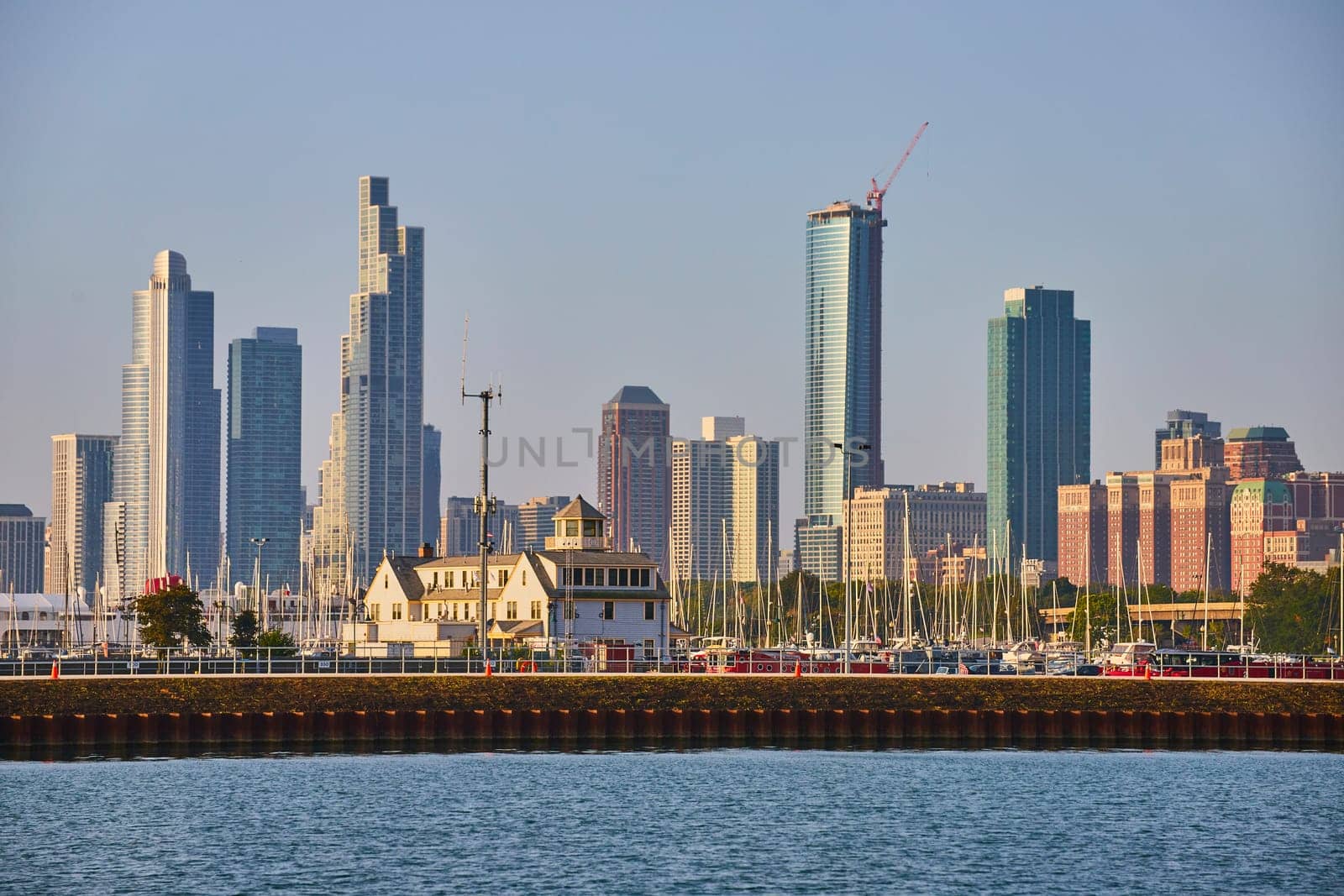 Chicago skyscraper skyline from beyond Lake Michigan water, harbor with boats on other side of pier by njproductions