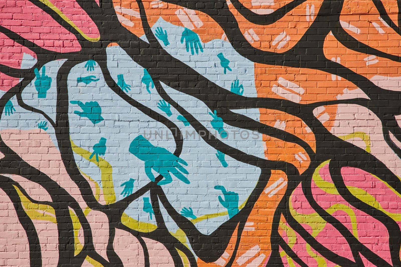 Vibrant Urban Mural in Downtown Muncie, Indiana, 2023 - Colorful Artwork of Organic Shapes and Handprint Silhouettes on Brick Wall