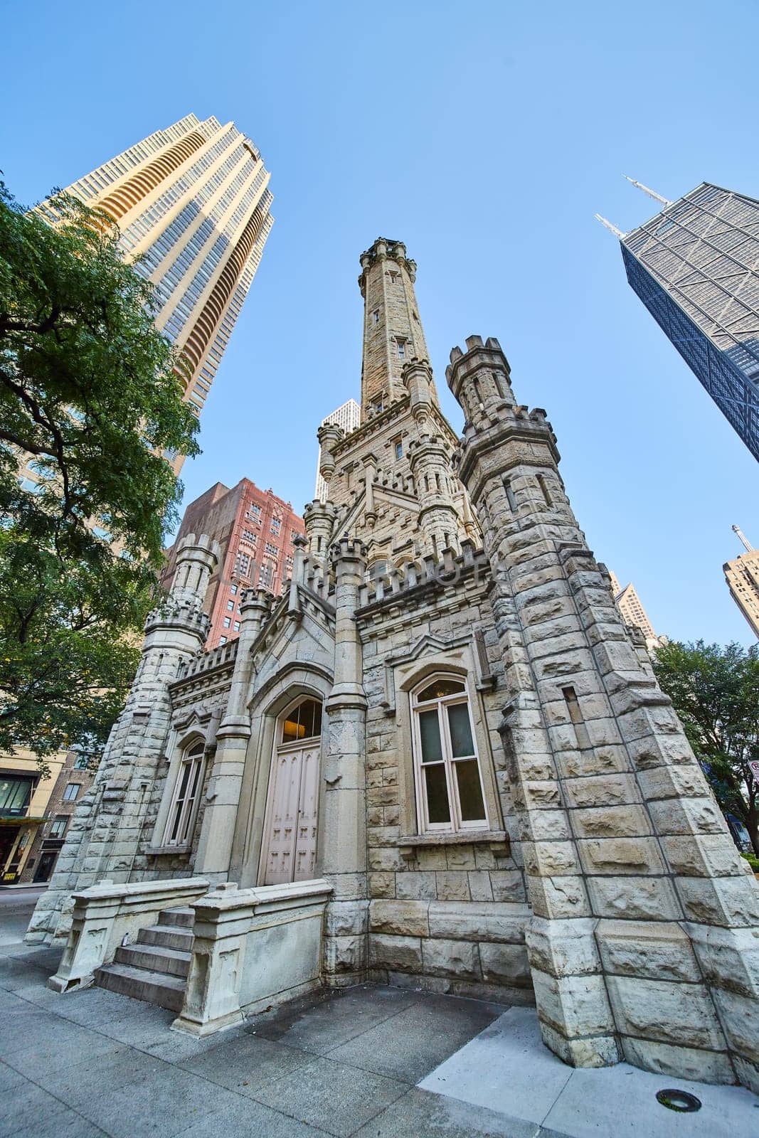 Image of Castle in Chicago city, historic, original water tower on blue sky day, tourism, tourist attraction