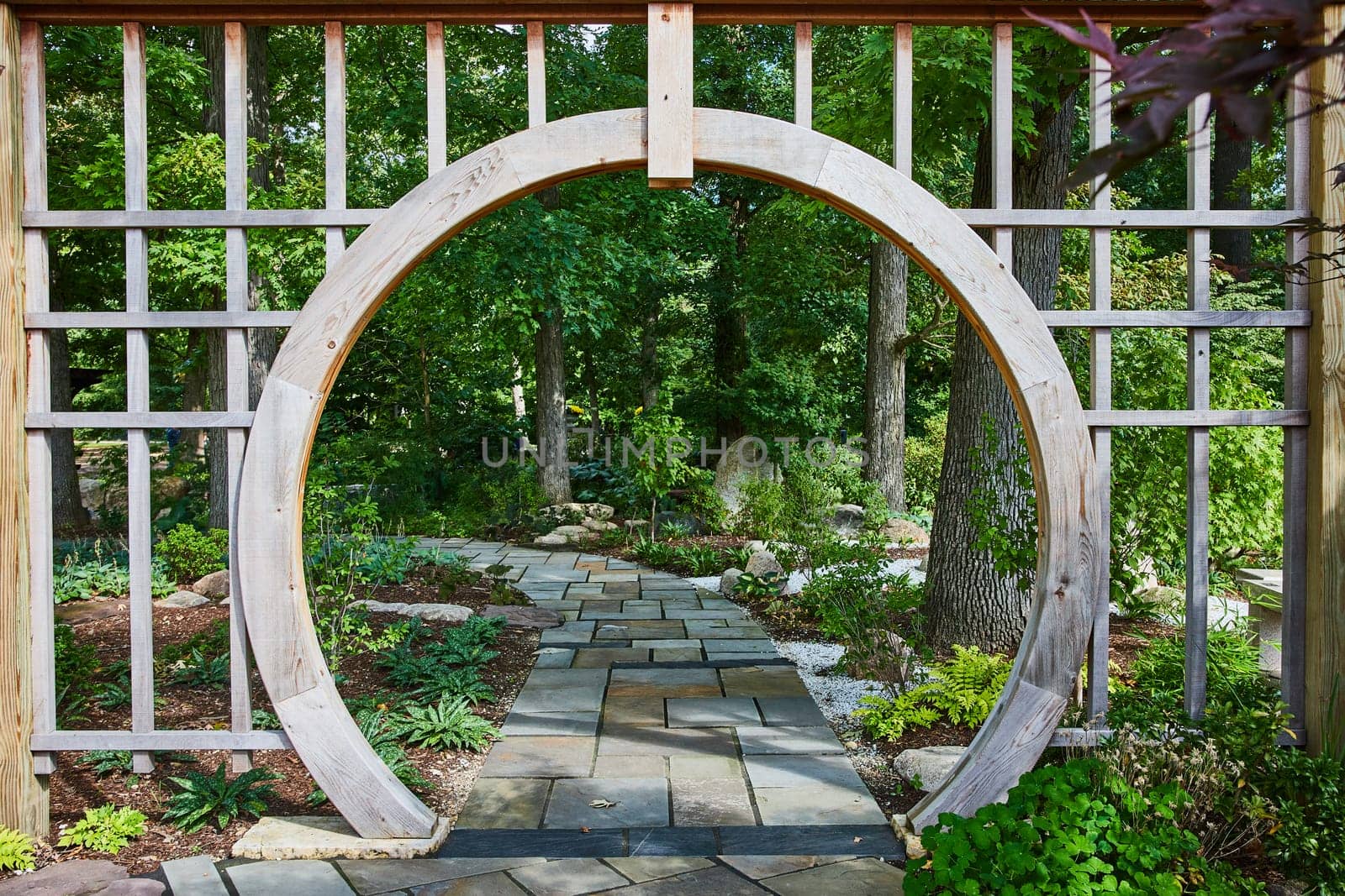 Serene Garden with Wooden Archway and Flagstone Path in Elkhart by njproductions