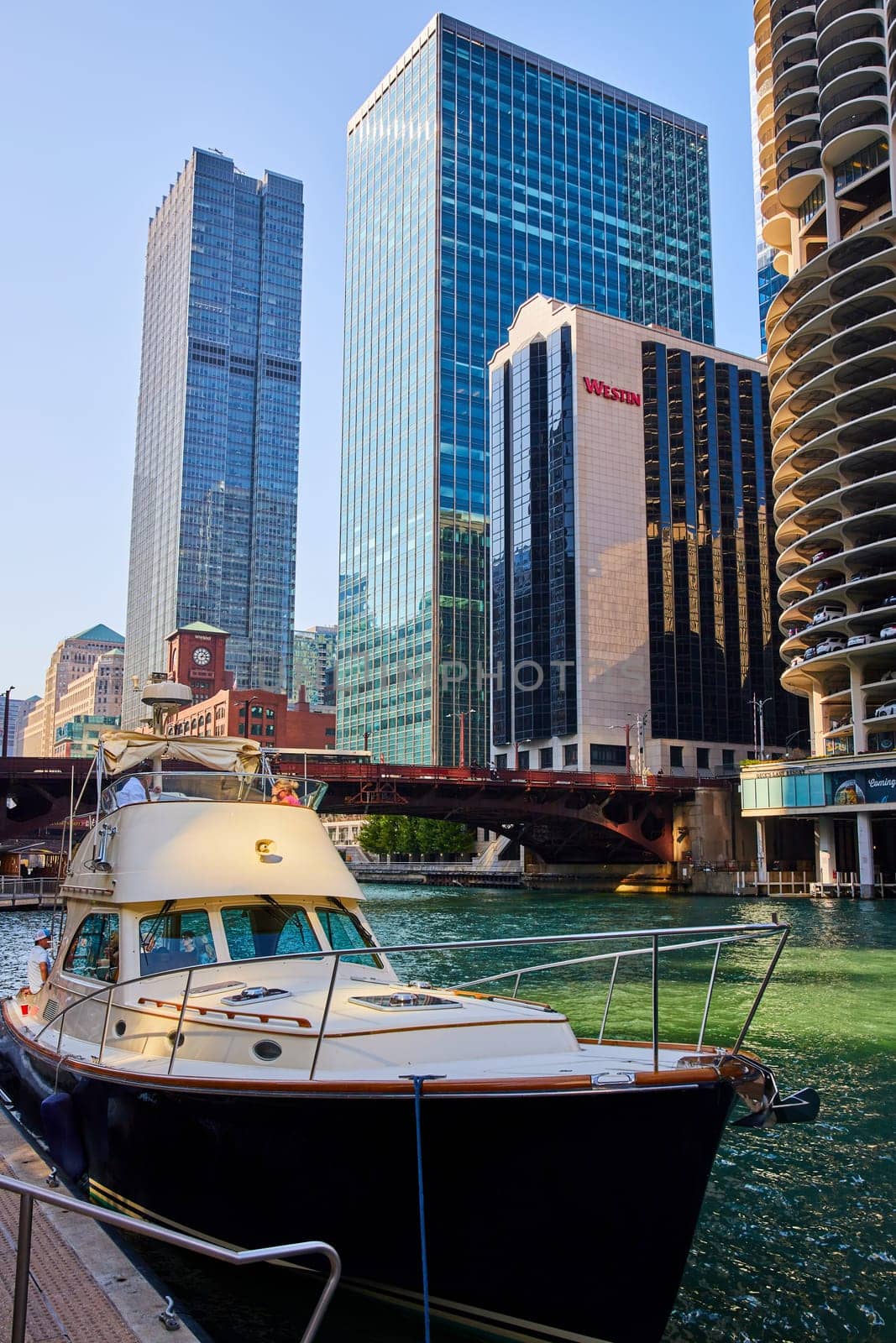 Boat close up with Chicago canal and bridge with skyscraper hotel and offices background, Illinois by njproductions