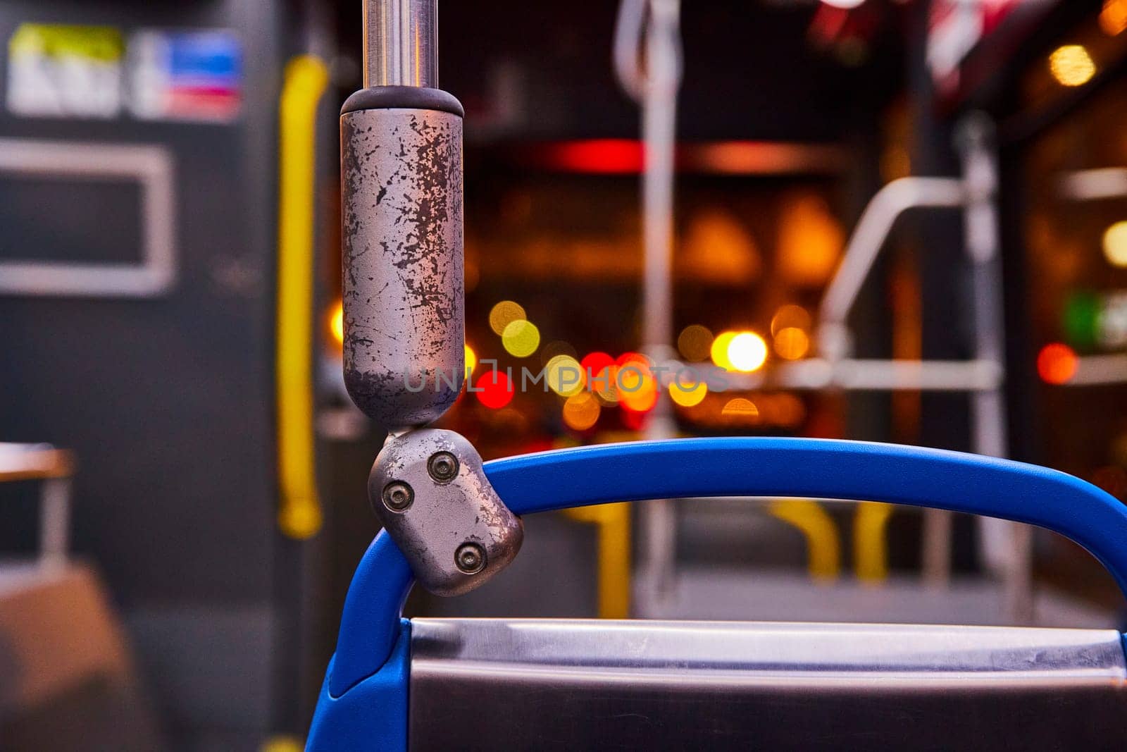 Image of Railing, handlebar in bus at night close up, colorful blurred city lights, transit, transportation