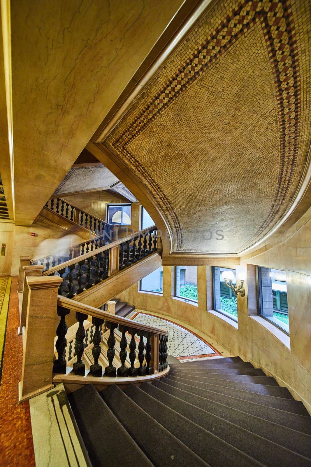 Image of Elaborate winding staircases with multiple levels and curved wall with windows