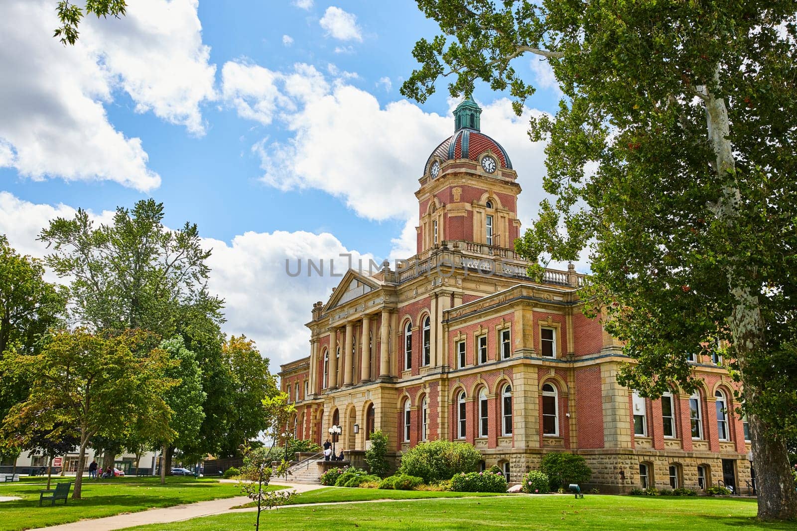 Image of Elkhart County courthouse, IN on blue sky day with fluffy white clouds, law and order, summer day