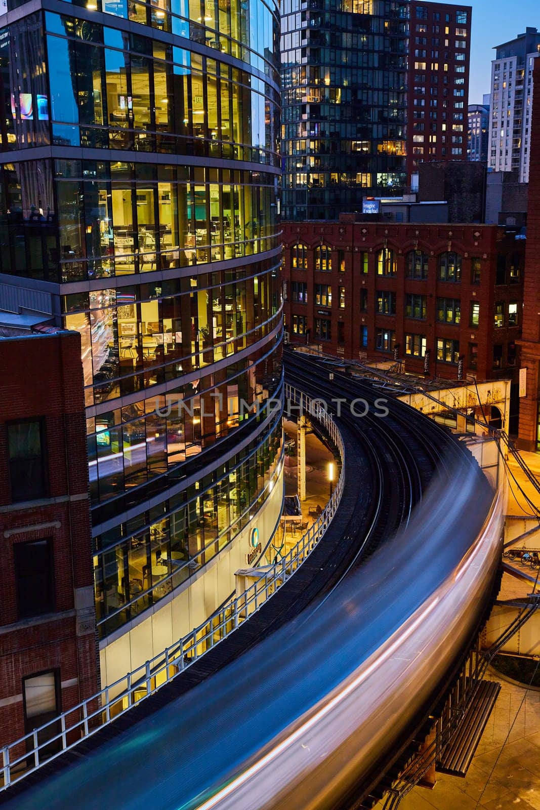 Twilight train in motion along the tracks, showcasing the blend of historical and modern architecture in 2023 Chicago, Illinois