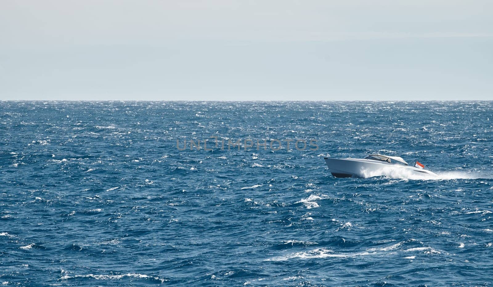 A motorboat is sailing at high speed in the sea near Monaco by vladimirdrozdin