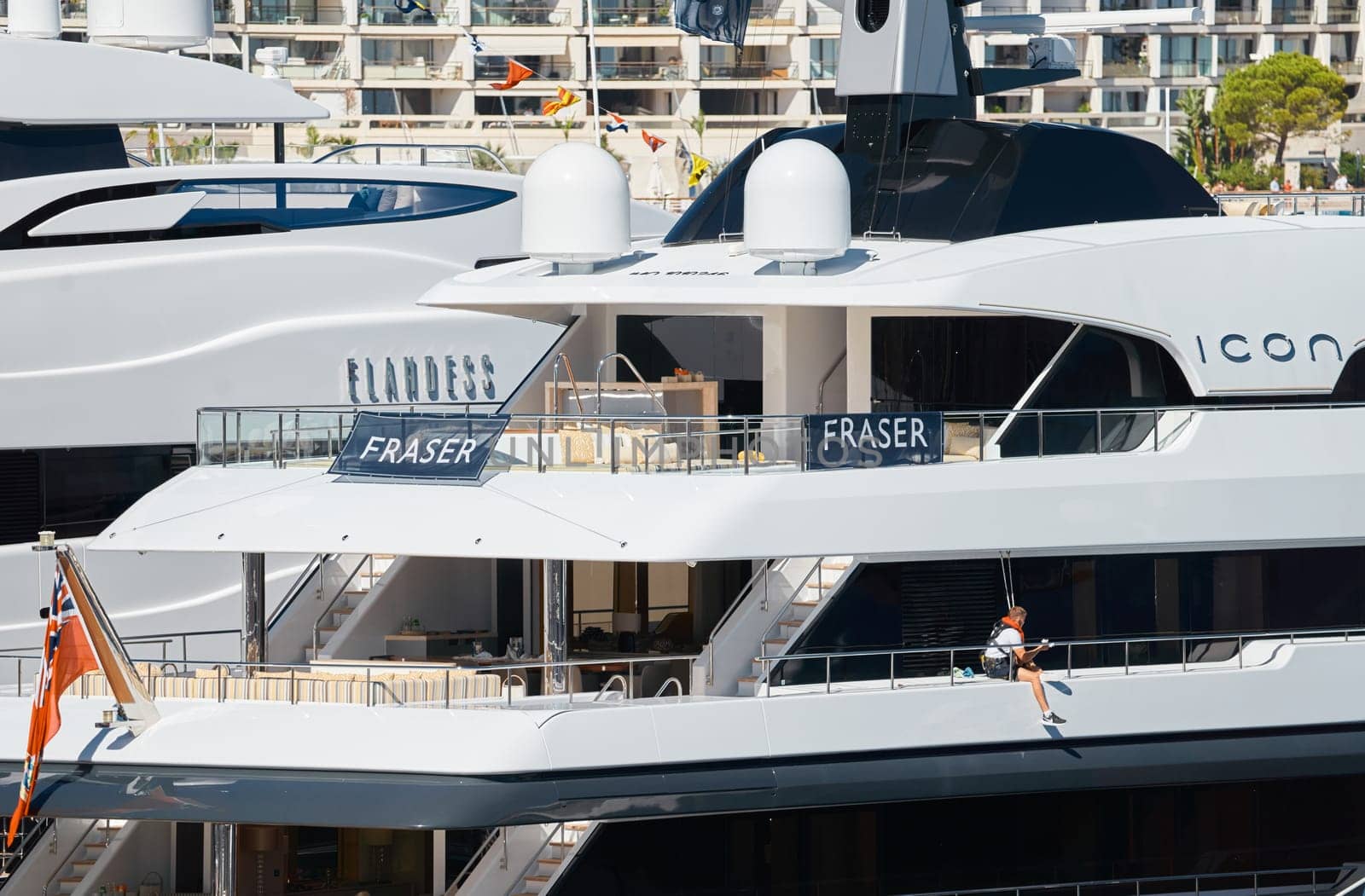 Monaco, Monte Carlo, 28 September 2022 - a member of the team washes the yacht and prepares the boat for the reception of guests at the famous motorboat exhibition in the principality, yacht brokers. High quality photo