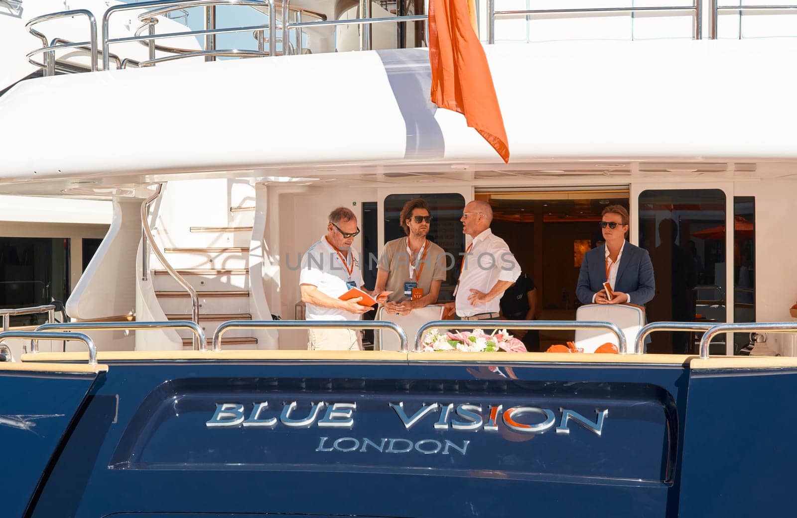 Monaco, Monte Carlo, 28 September 2022 - Invited wealthy clients inspect megayachts at the largest fair exhibition in the world yacht show MYS, port Hercules, yacht brokers, sunny weather. High quality photo