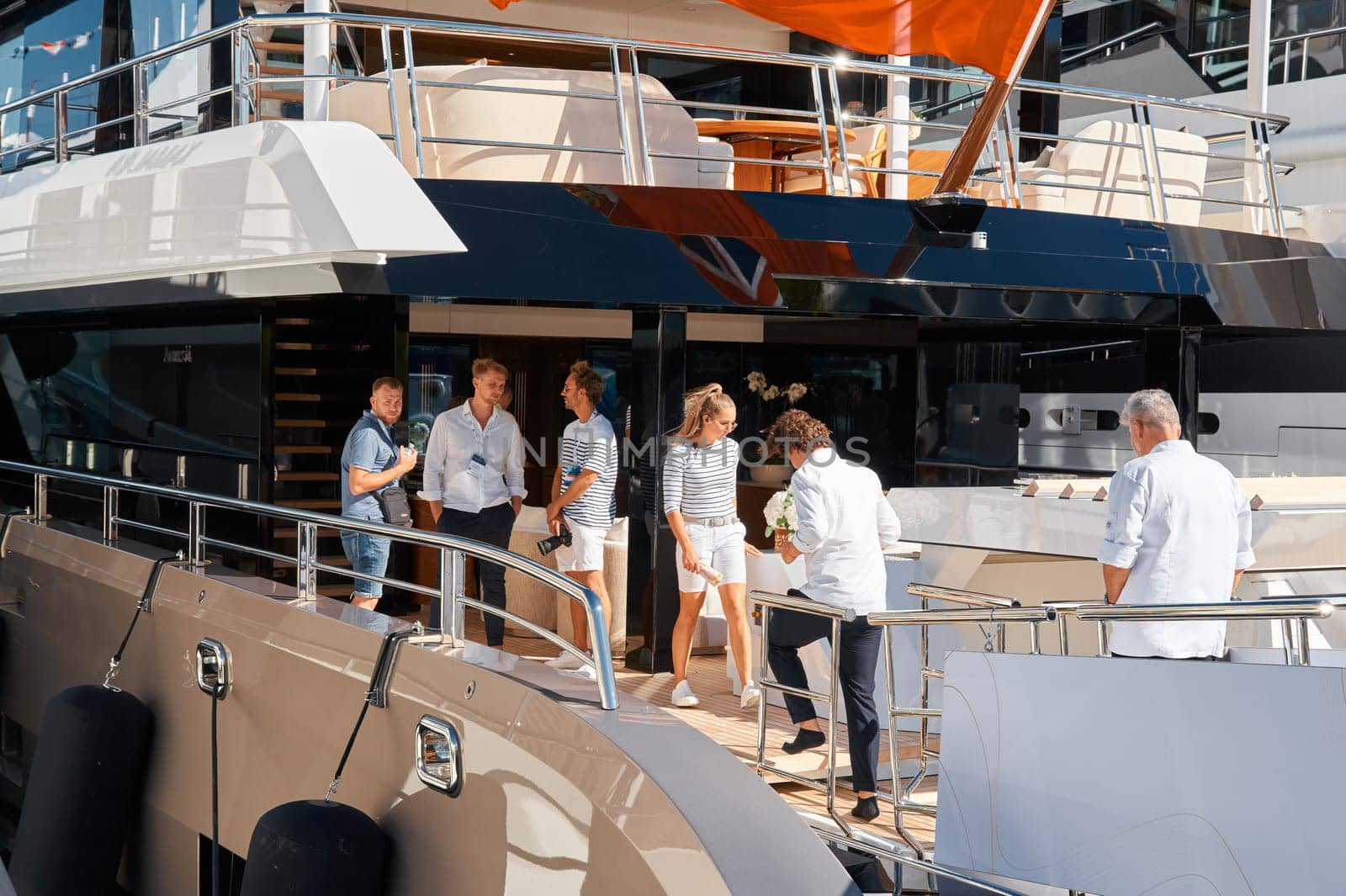 Monaco, Monte Carlo, 28 September 2022 - Invited wealthy clients inspect megayachts at the largest fair exhibition in the world yacht show MYS, port Hercules, yacht brokers, sunny weather. High quality photo