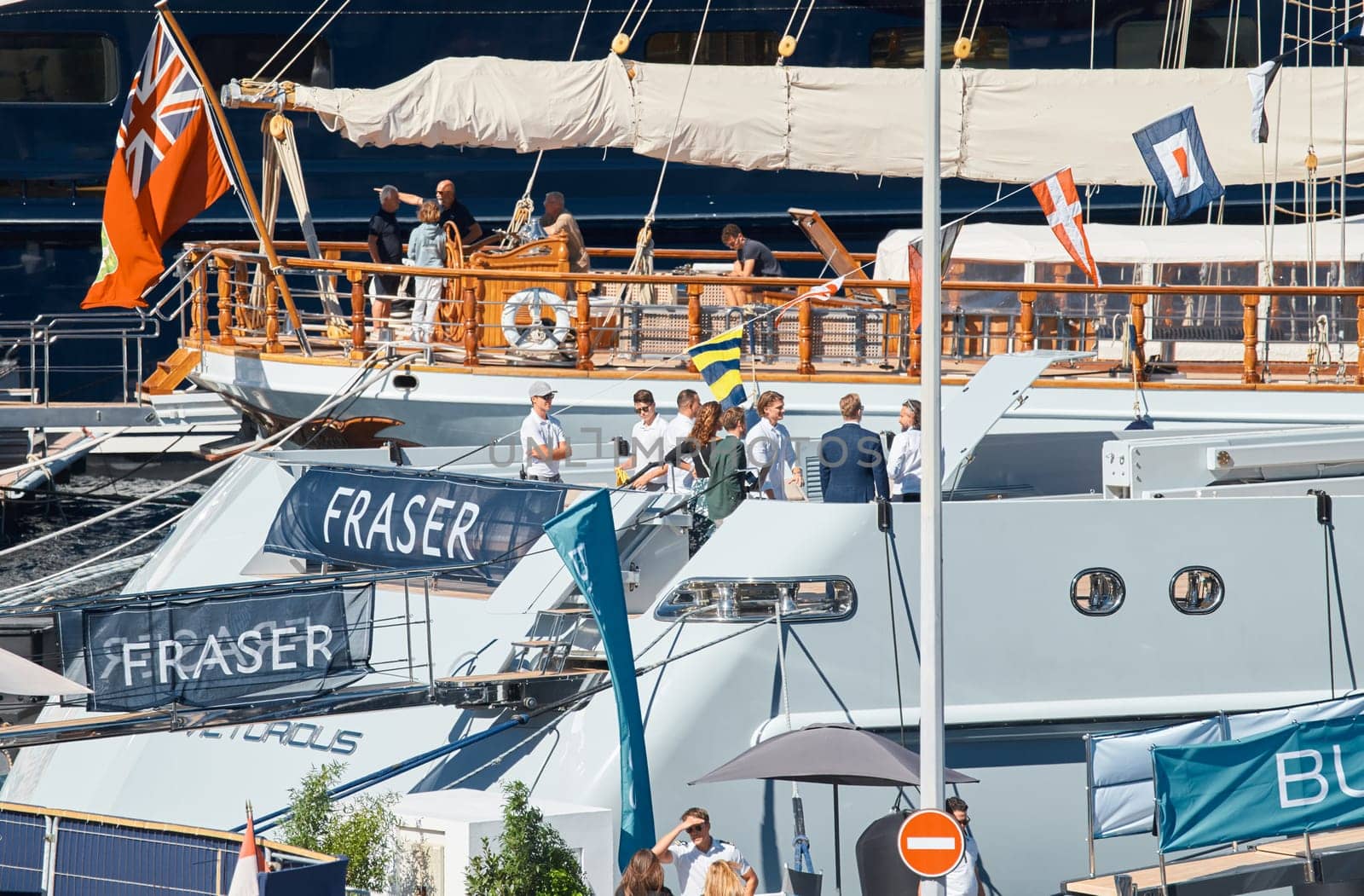 Monaco, Monte Carlo, 28 September 2022 - Invited wealthy clients inspect megayachts at the largest fair exhibition in the world yacht show MYS, port Hercules, yacht brokers, sunny weather. High quality photo