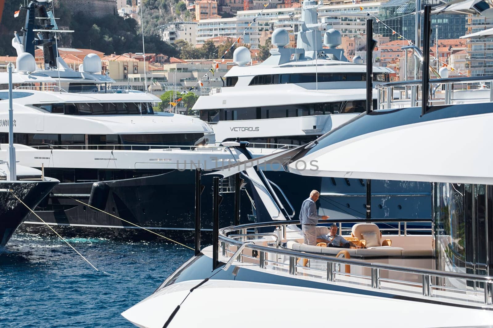 Monaco, Monte Carlo, 28 September 2022 - Invited wealthy clients inspect megayachts at the largest fair exhibition in the world yacht show MYS, port Hercules, yacht brokers, sunny weather by vladimirdrozdin