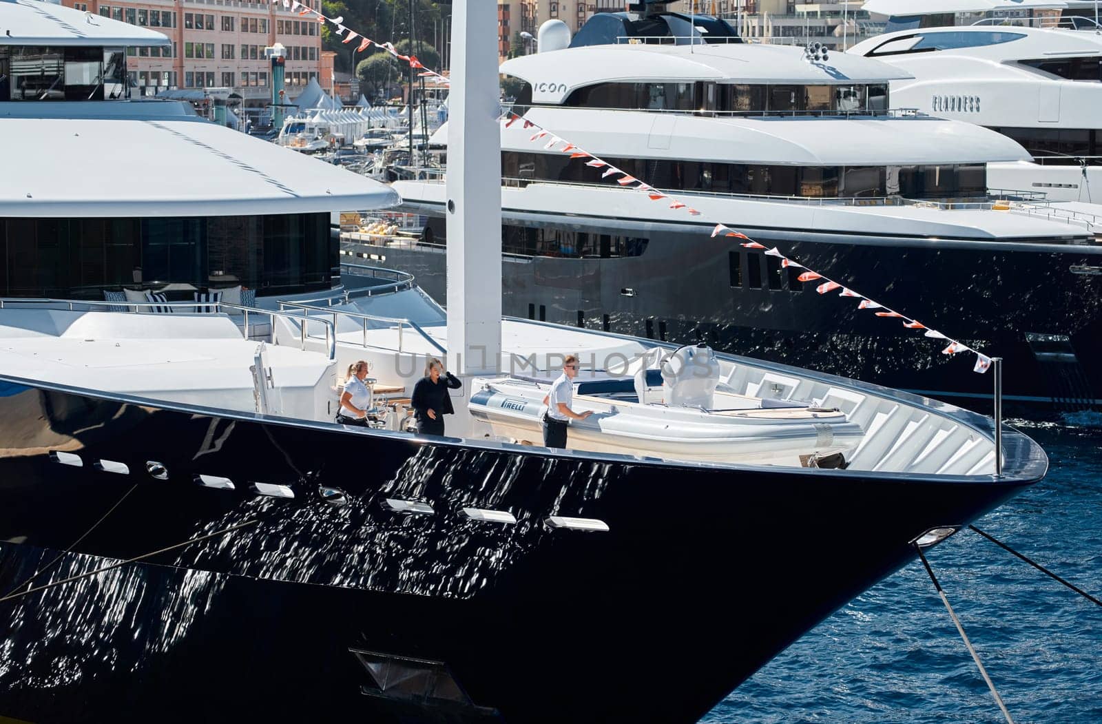 Monaco, Monte Carlo, 28 September 2022 - Invited wealthy clients inspect megayachts at the largest fair exhibition in the world yacht show MYS, port Hercules, yacht brokers, sunny weather. High quality photo