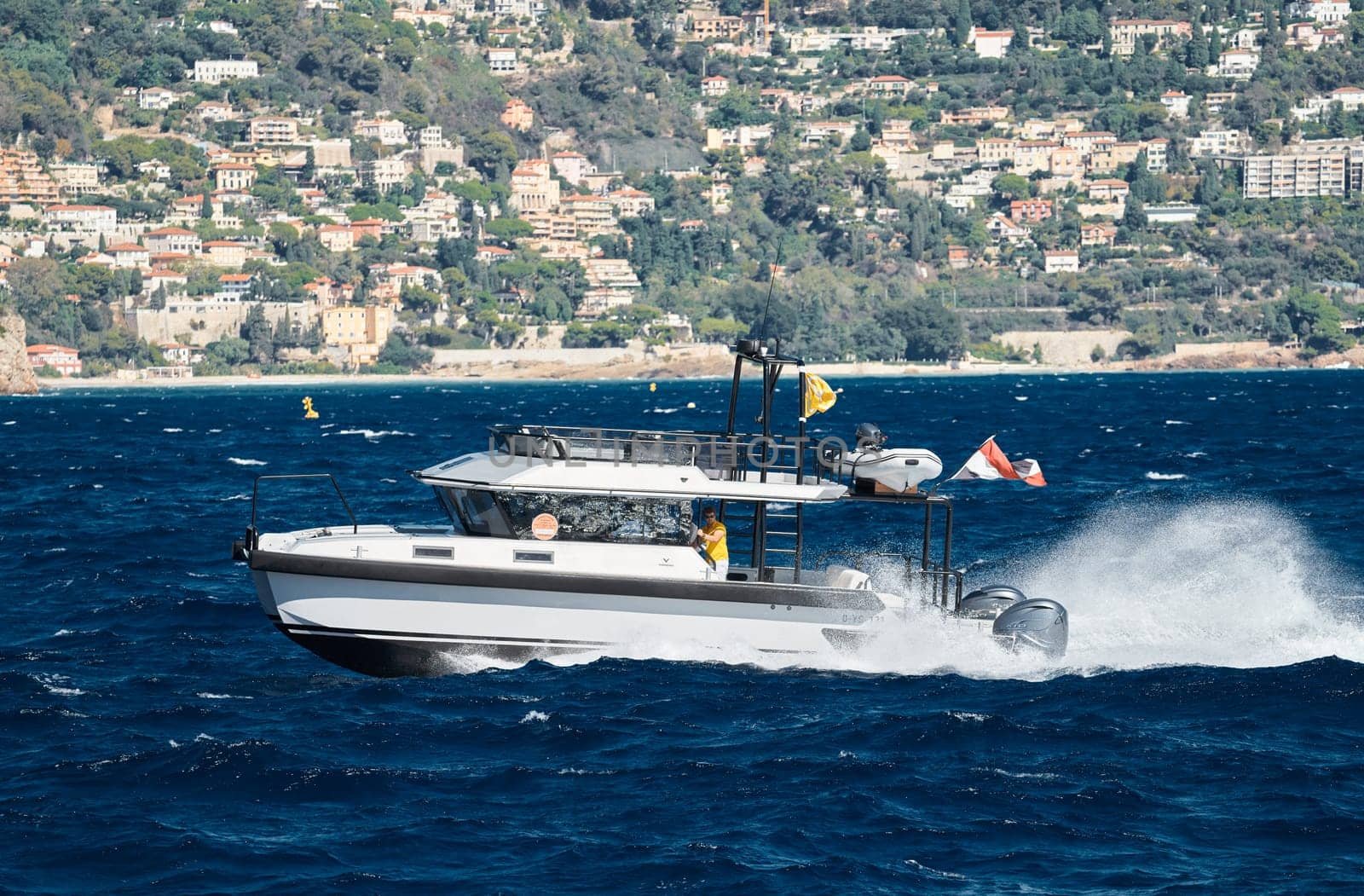 Monaco, Monte Carlo, 28 September 2022 - a motor boat with guests of yacht brokers departs from the shore in the largest fair exhibition in the world yacht show MYS, port Hercules, rich clients, sunny by vladimirdrozdin