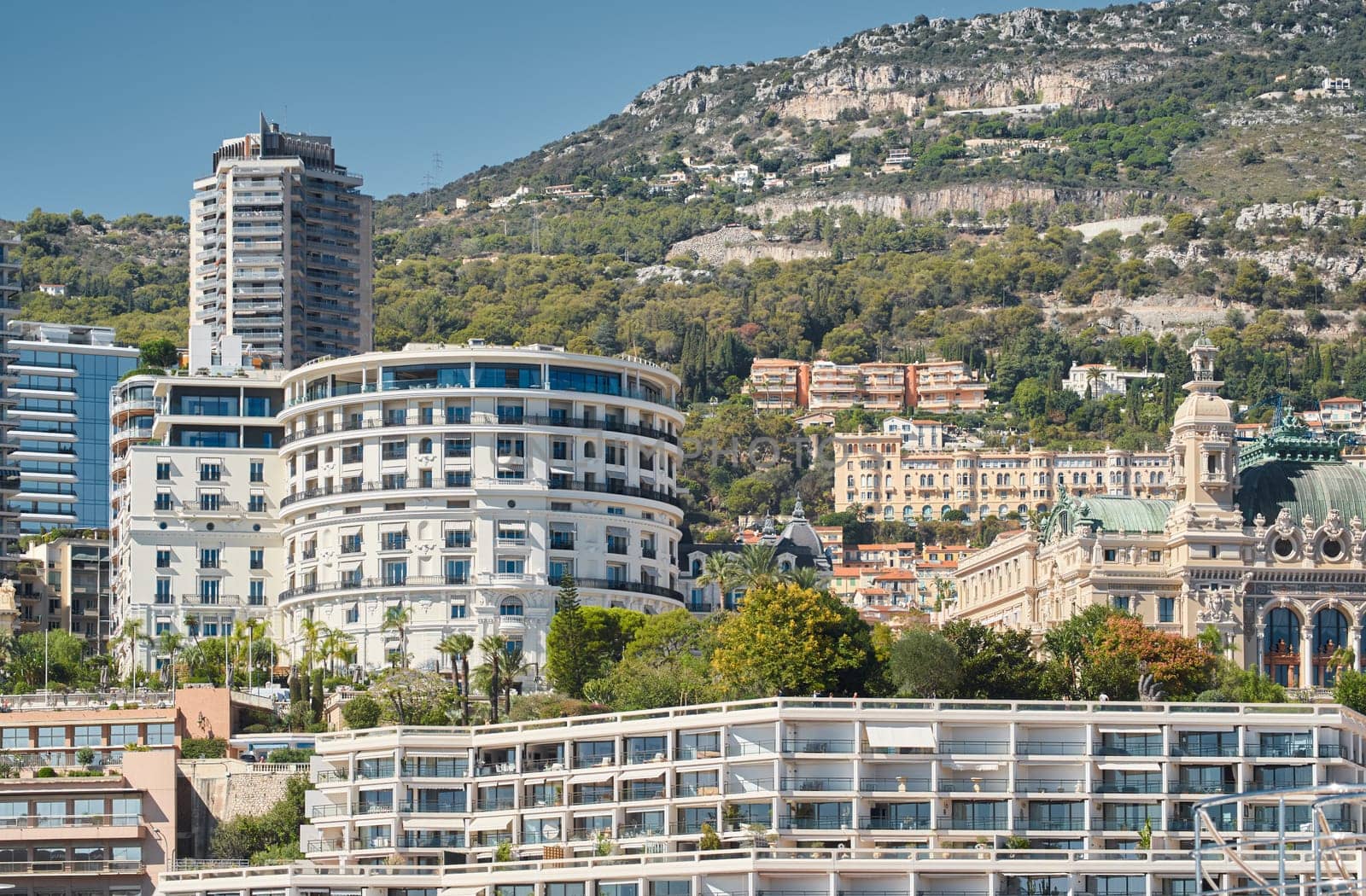 Monaco, Monte-Carlo, 28 September 2022 - Famous landmark Casino Monte-Carlo and hotel de Paris at sunny day, mountain on background, wealth life by vladimirdrozdin