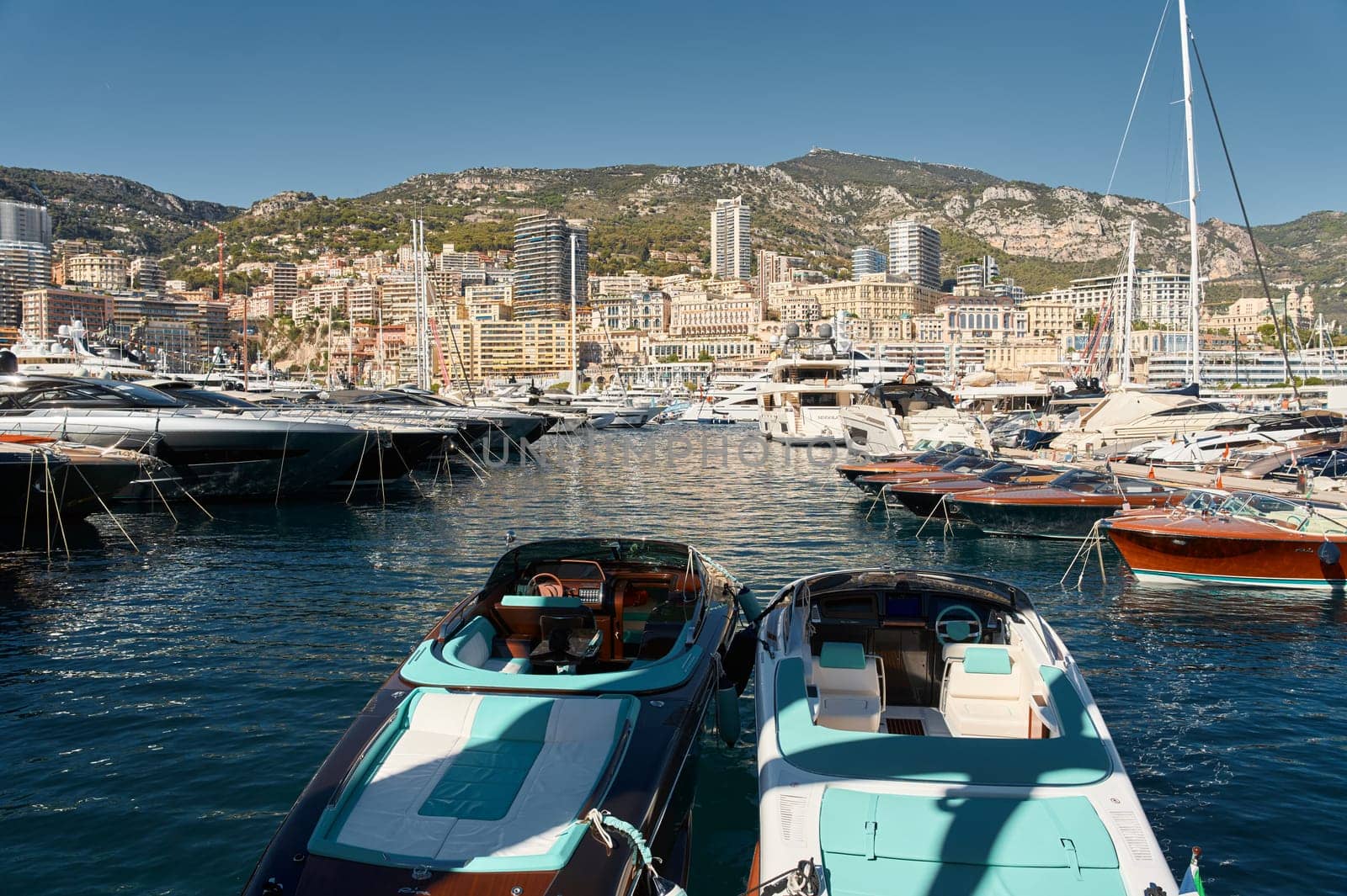 Monaco, Monte Carlo, 28 September 2022 - Riva boats in a row and a lot of luxury mega yachts at the famous motorboat exhibition in the principality, yacht brokers and clients by vladimirdrozdin