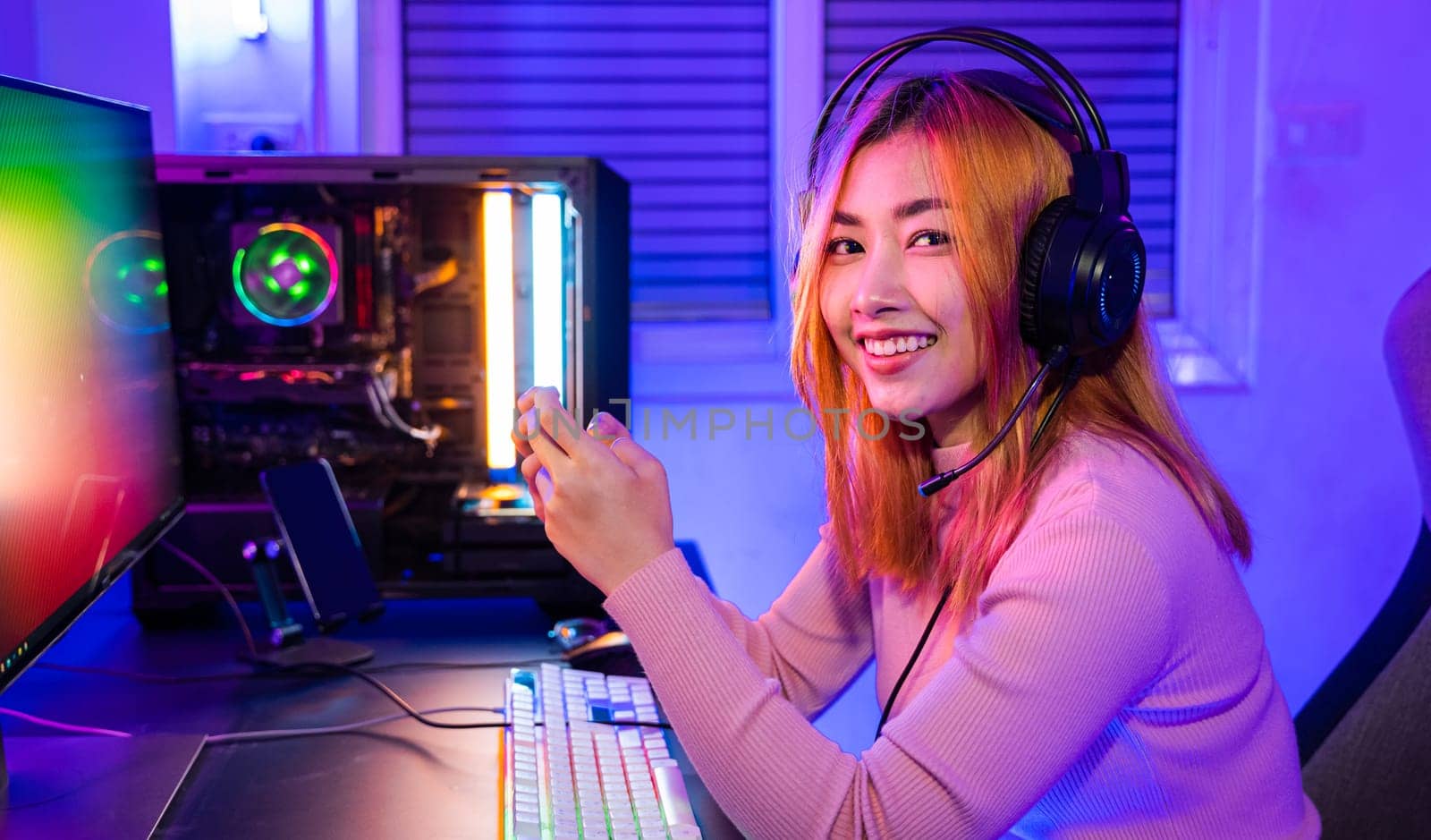 Smiling Asian woman live stream she play video game via smartphone by Sorapop