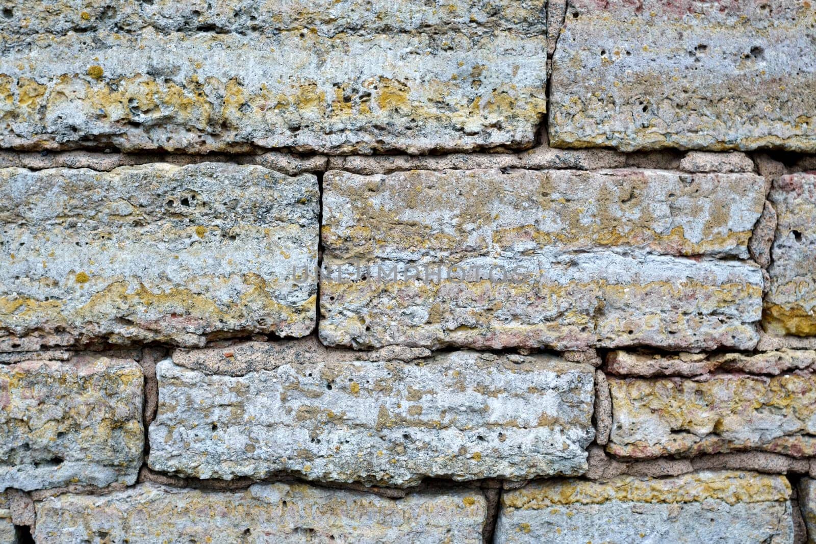 Textured Bricks, stone Background. The worn facade of the building