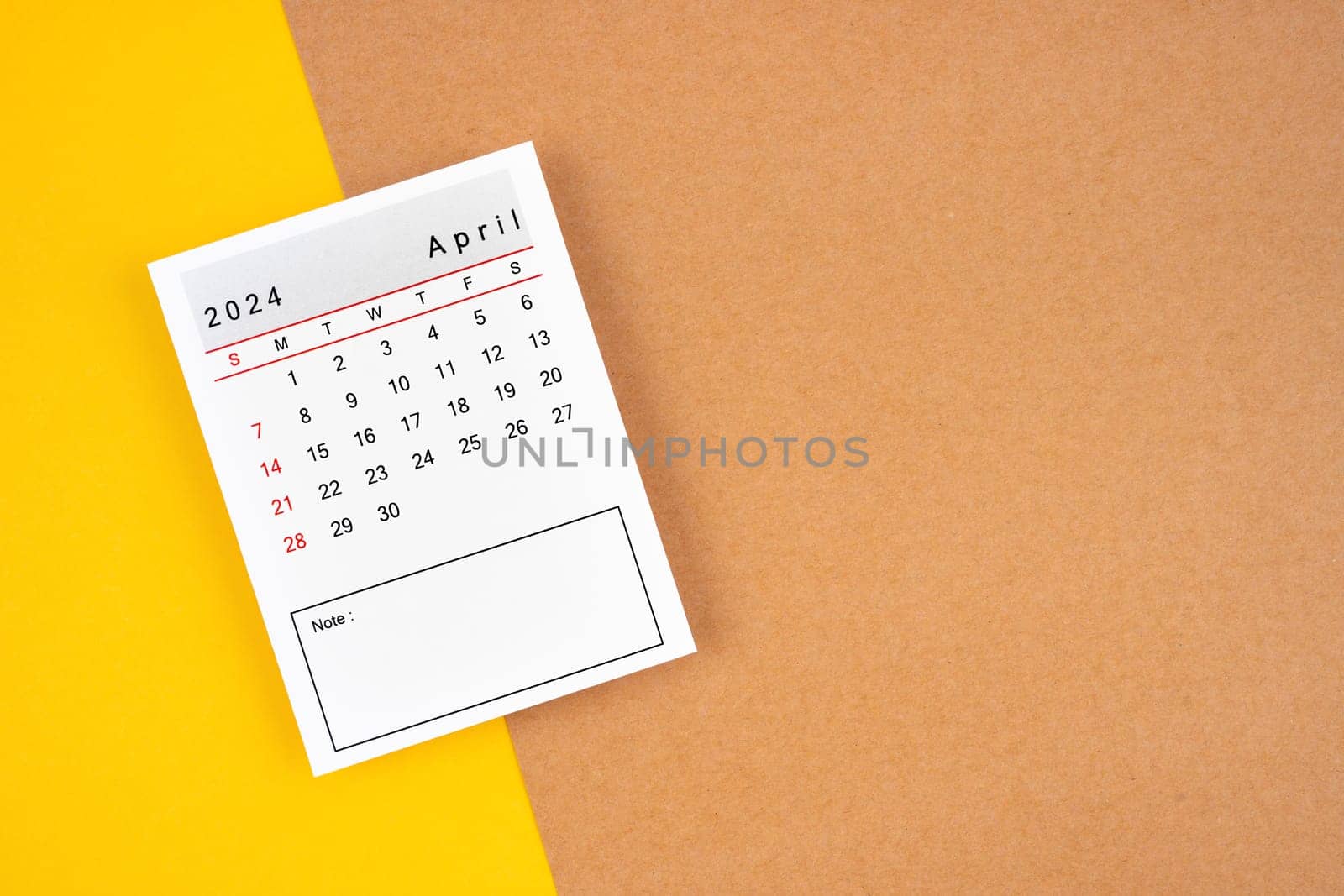 Calendar page for April 2024 on a brown background. by Gamjai