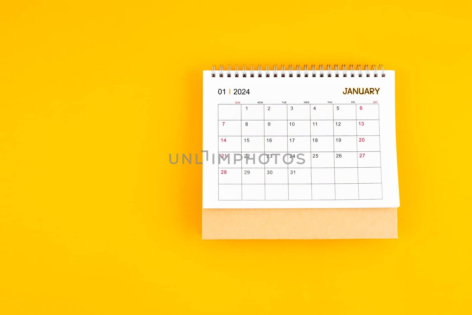January 2024 desk calendar on yellow color background, Position with copy space.  by Gamjai