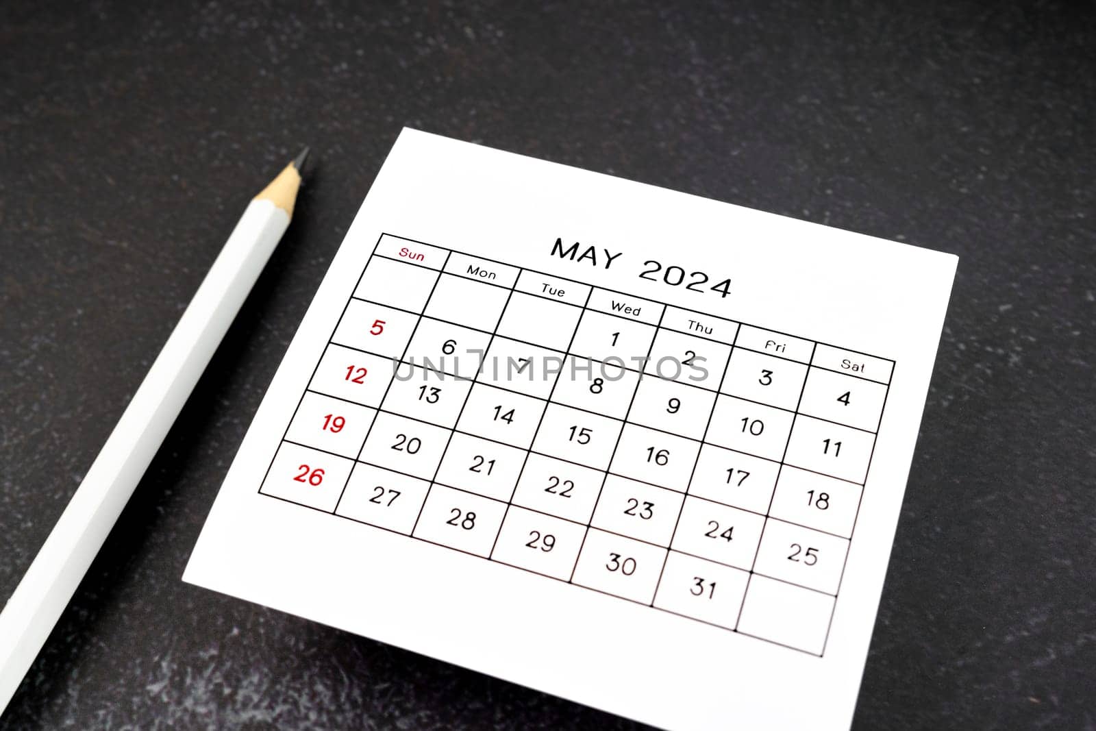 White calendar page for May 2024 and pencil. by Gamjai