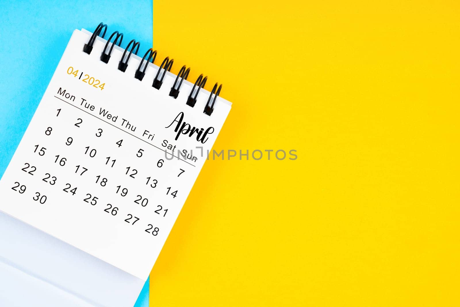April 2024, Monthly desk calendar for 2024 year on yellow and blue color background.