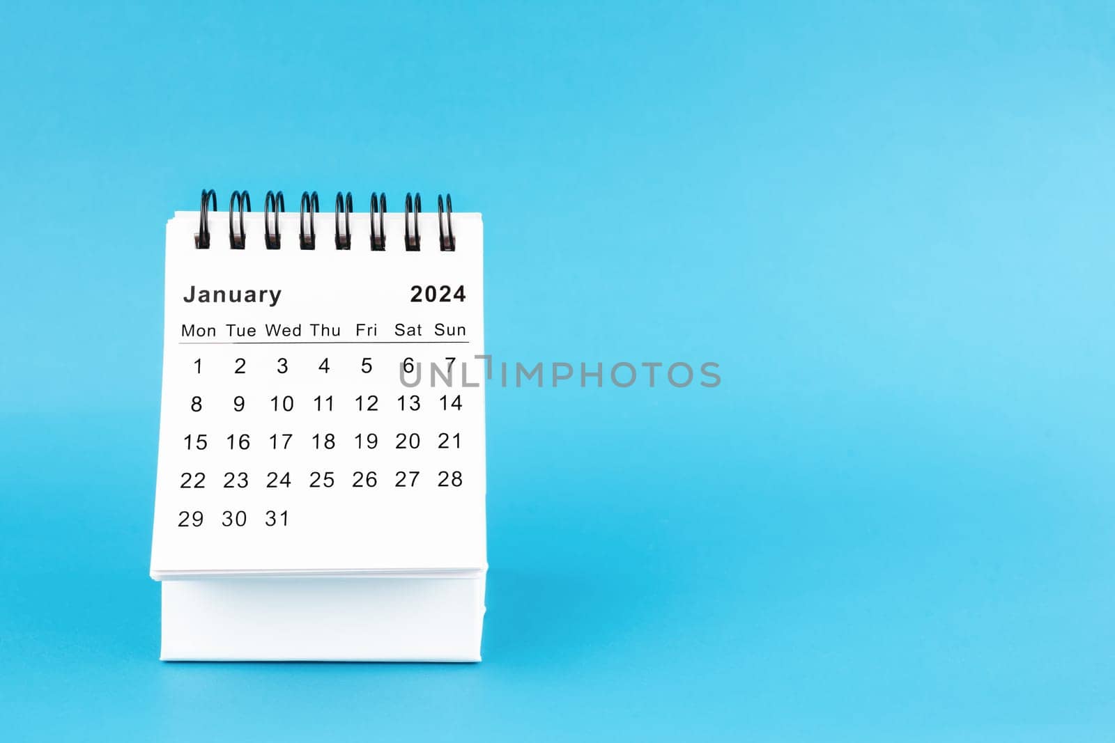 January 2024 desk calendar isolated in blue color background.