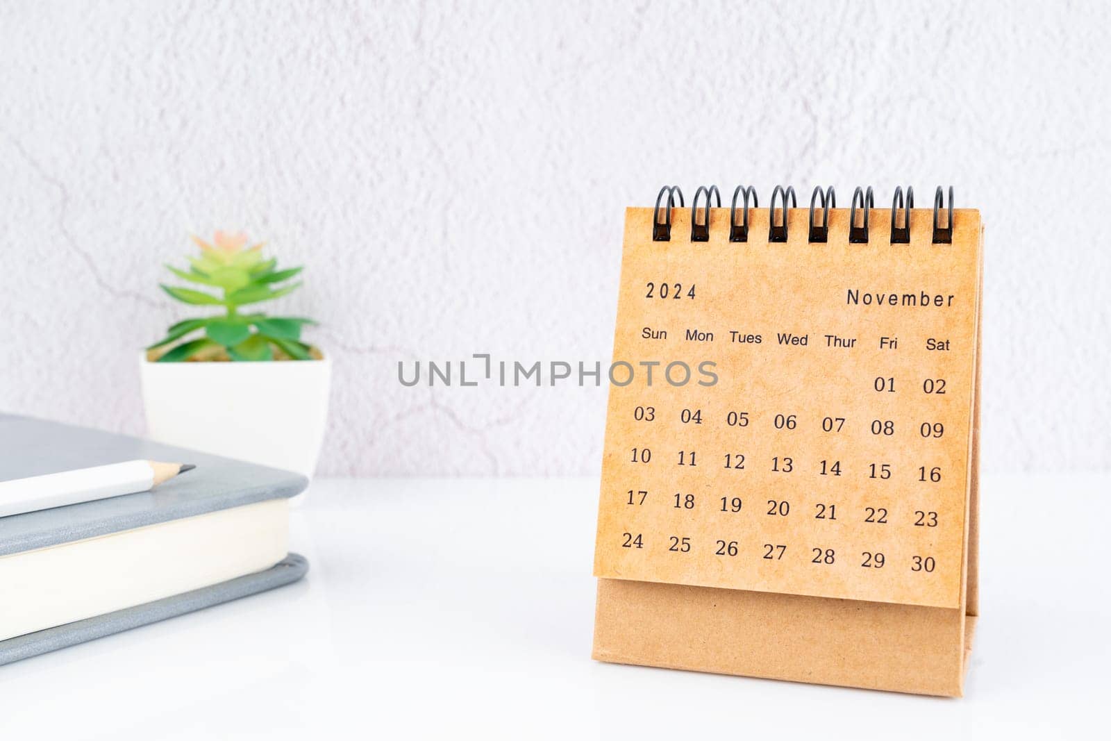 November 2024, Monthly desk calendar for 2024 year on the table. by Gamjai