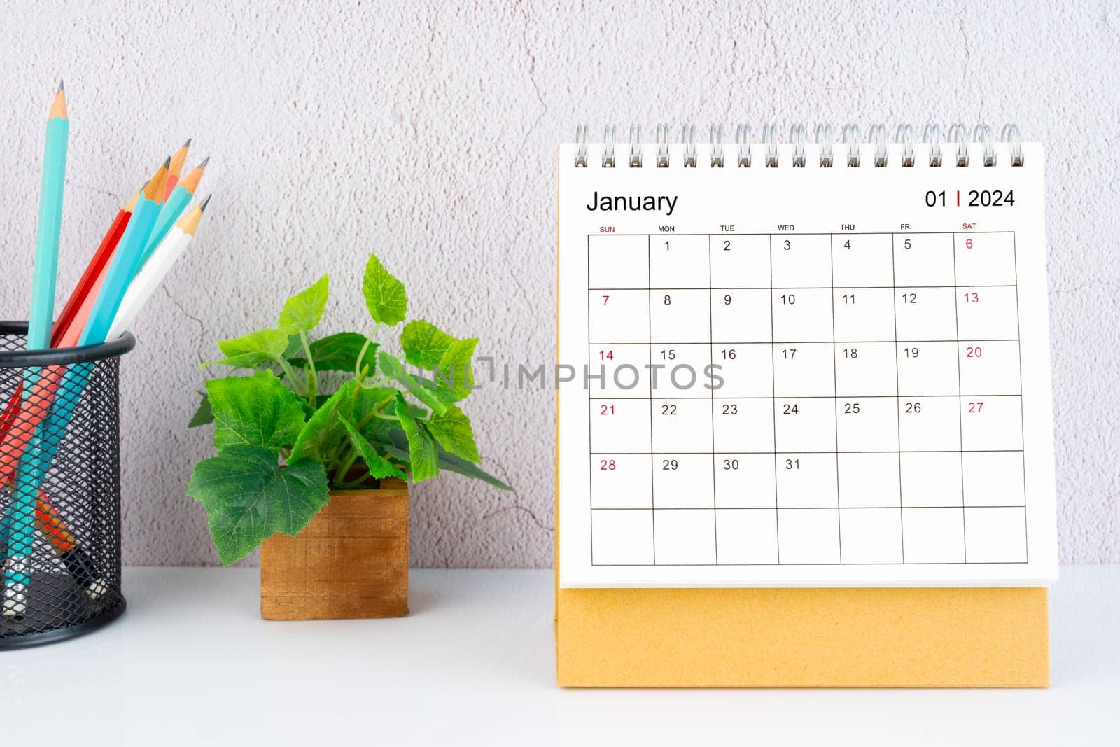 January 2024 Desk Calendar with pencil on white table.
