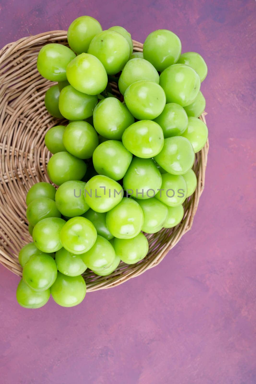 Sweet Green Shine Muscat grape in Bamboo basket. by Gamjai