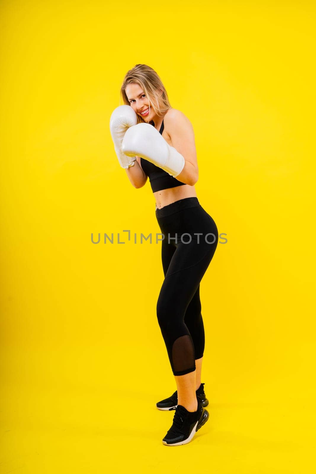 Smiling focused female boxer, concept of individual sport, active lifestyle, health, competition by Zelenin