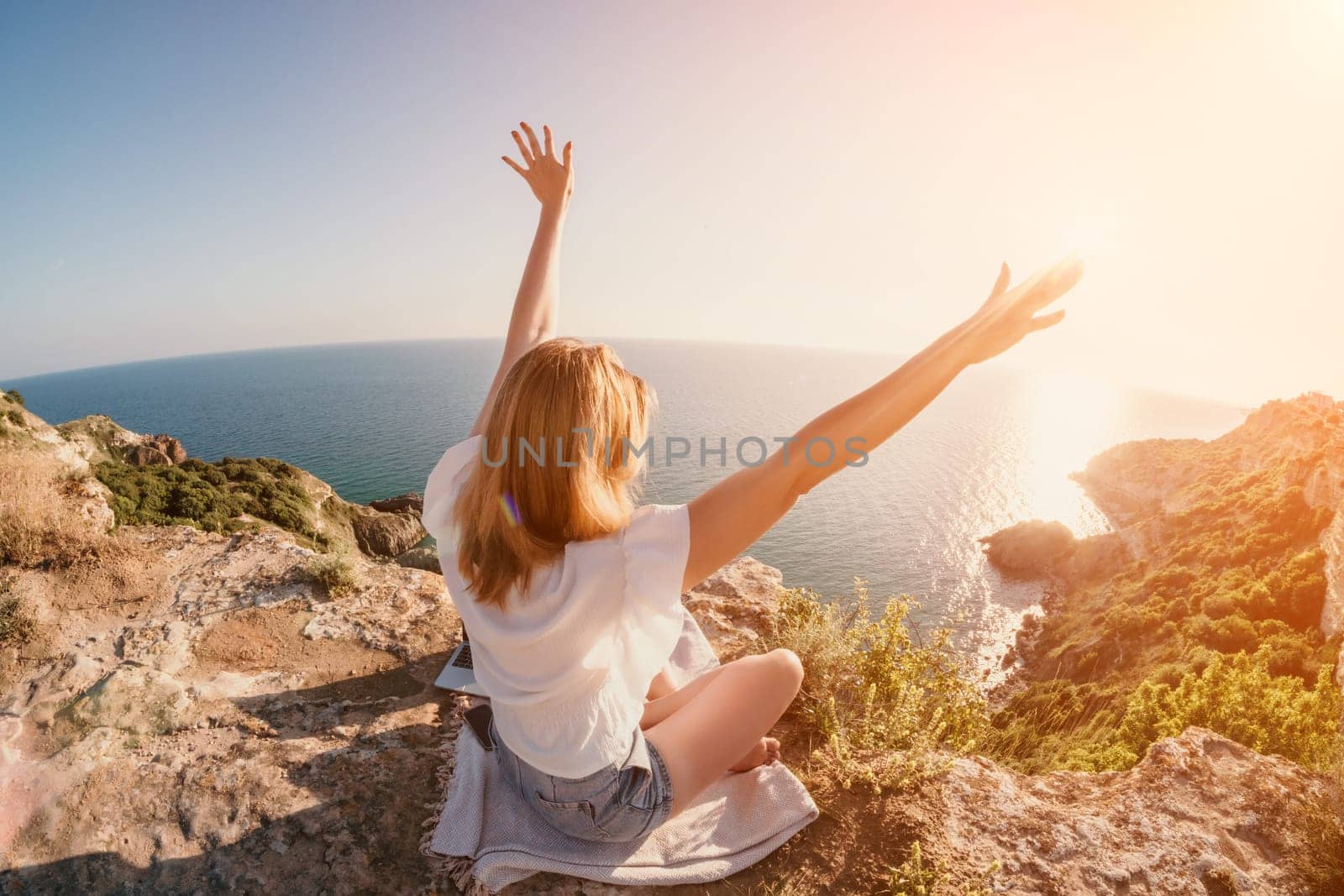 Woman sea laptop. Business woman working on laptop by sea at sunset. Close up on hands of pretty lady typing on computer outdoors summer day. Freelance, digital nomad, travel and holidays concept. by panophotograph