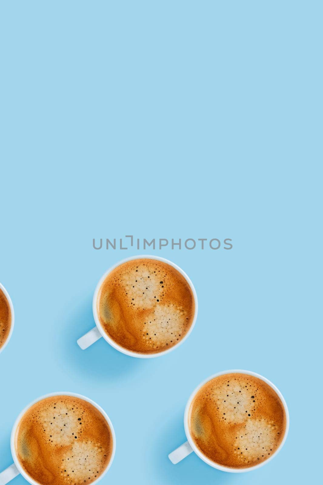 Morning cups of strong coffee on blue background.