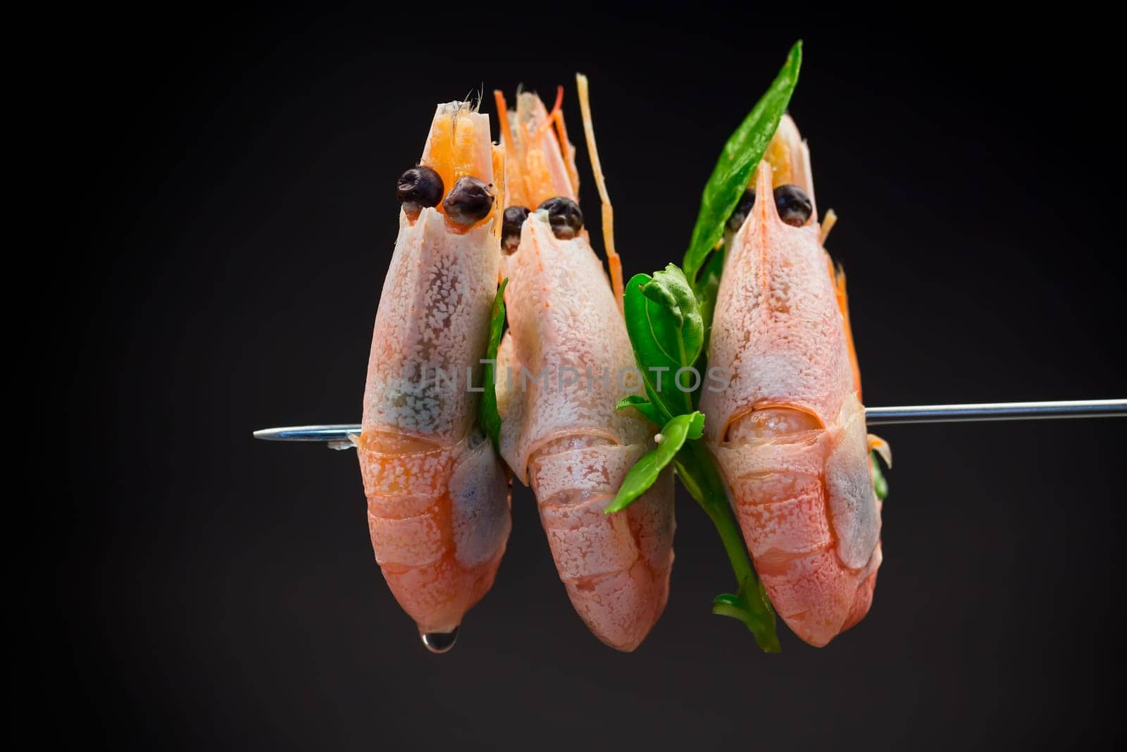 boiled shrimp with spices isolated on black background