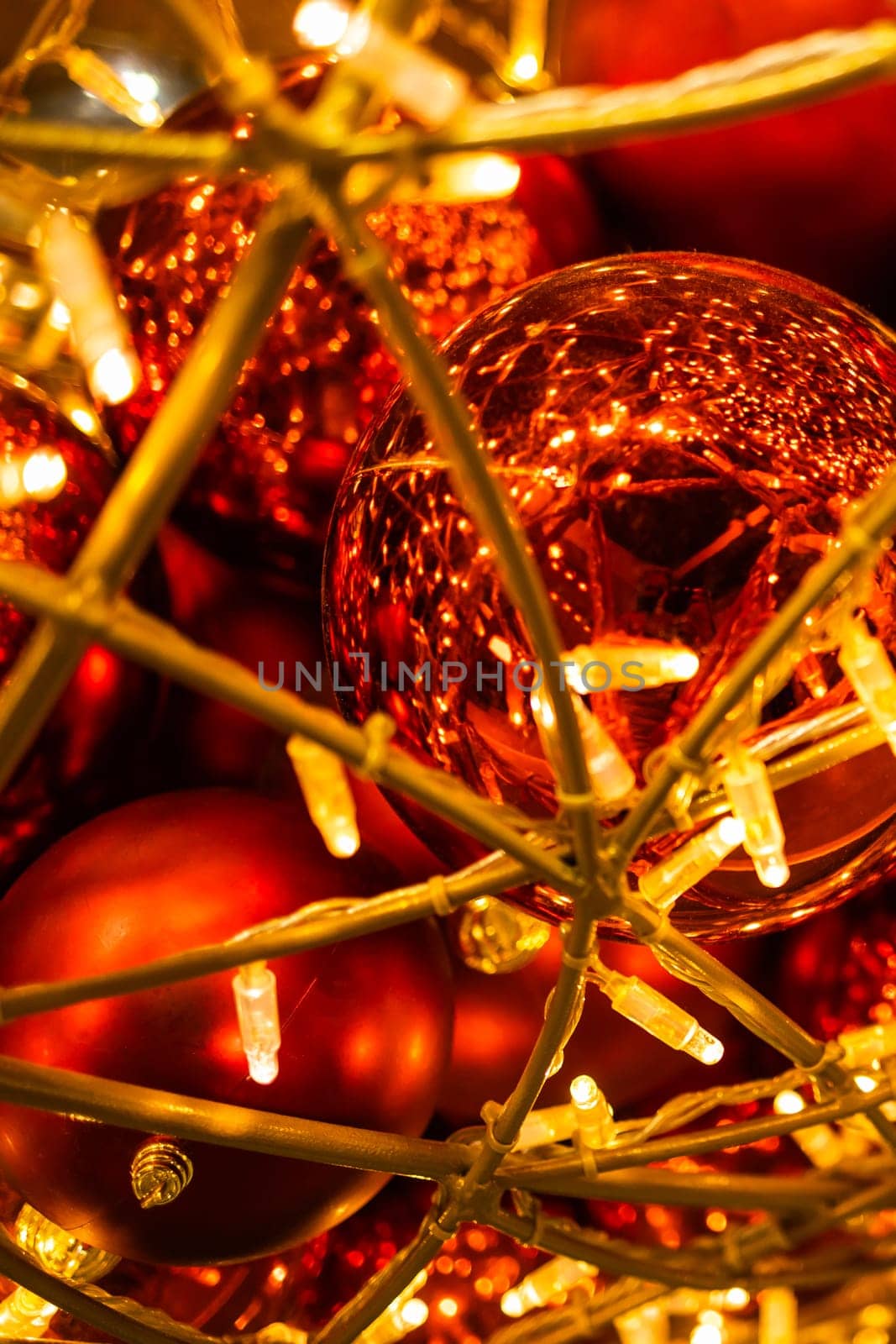 Close up of red Christmas balls baubles. Bokeh garlands. Xmas and holidays concept. Copy space and empty place for text, mock up greeting card.