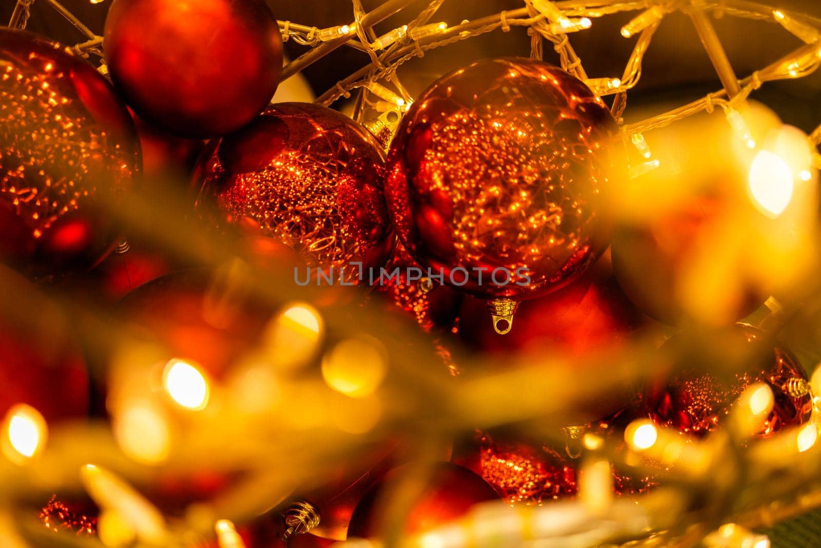 Close up of red Christmas balls baubles. Bokeh garlands. Xmas and holidays concept. Copy space and empty place for text, mock up greeting card.