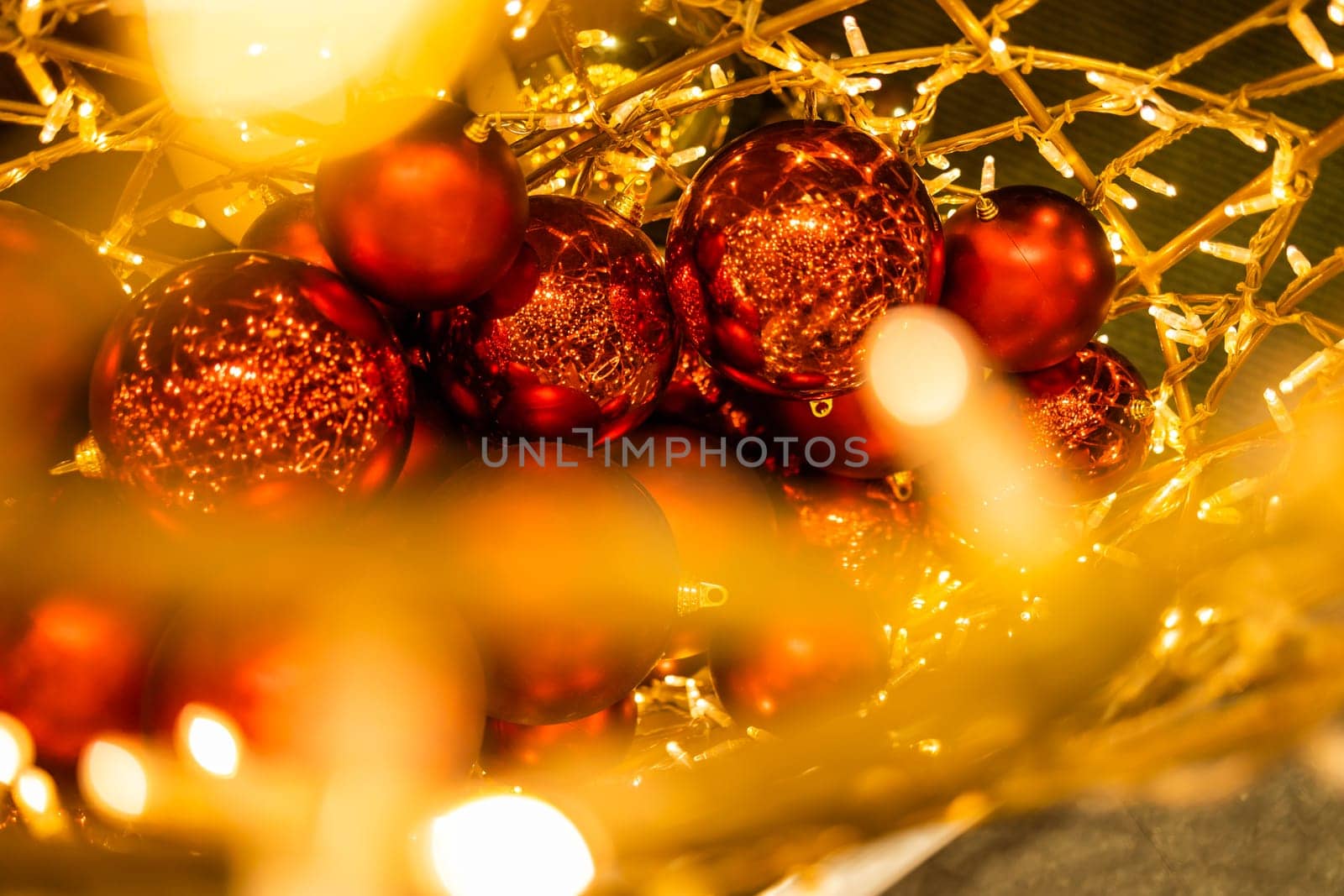 Close up of red Christmas balls baubles. Bokeh garlands. Xmas and holidays concept. Copy space and empty place for text, mock up greeting card.