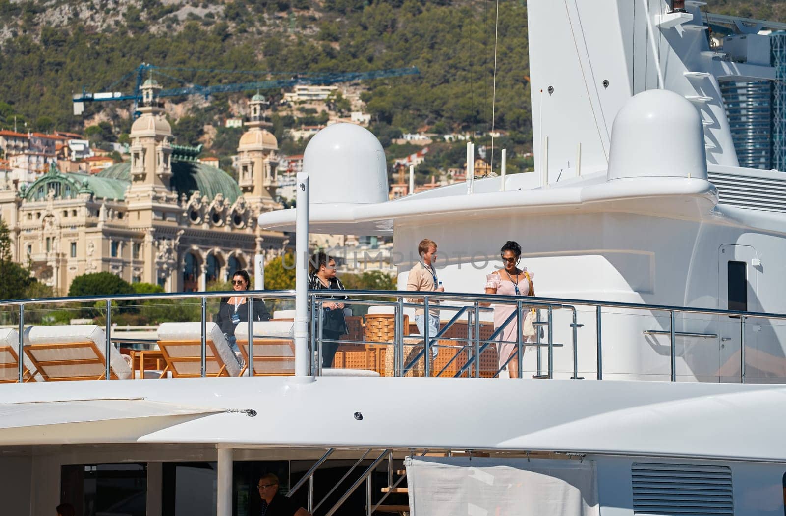 Monaco, Monte Carlo, 28 September 2022 - Invited wealthy clients inspect megayachts at the largest fair exhibition in the world yacht show MYS, port Hercules, yacht brokers, sunny weather. High quality photo