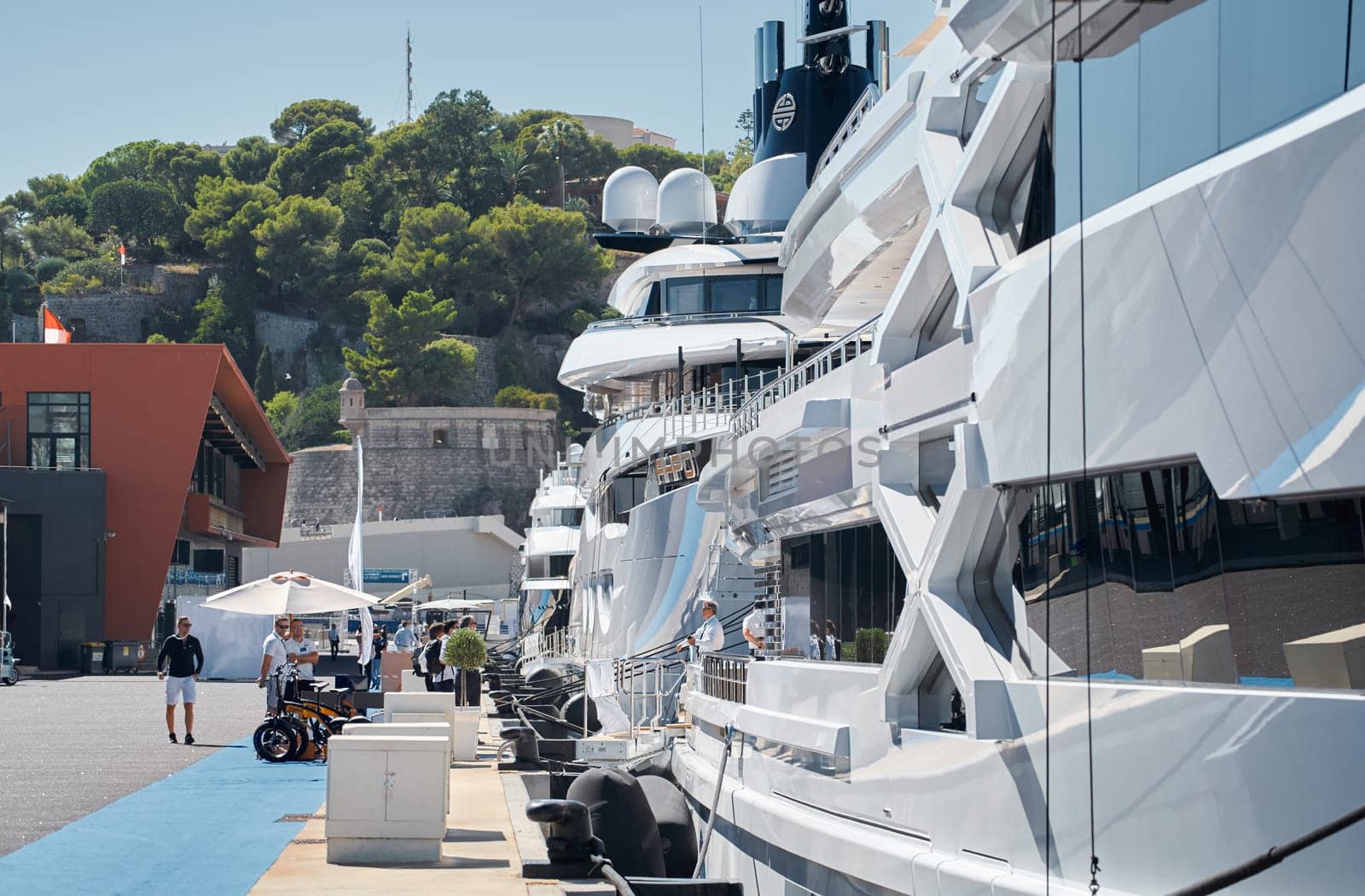 Monaco, Monte Carlo, 28 September 2022 - Invited wealthy clients inspect megayachts at the largest fair exhibition in the world yacht show MYS, port Hercules, yacht brokers, sunny weather by vladimirdrozdin