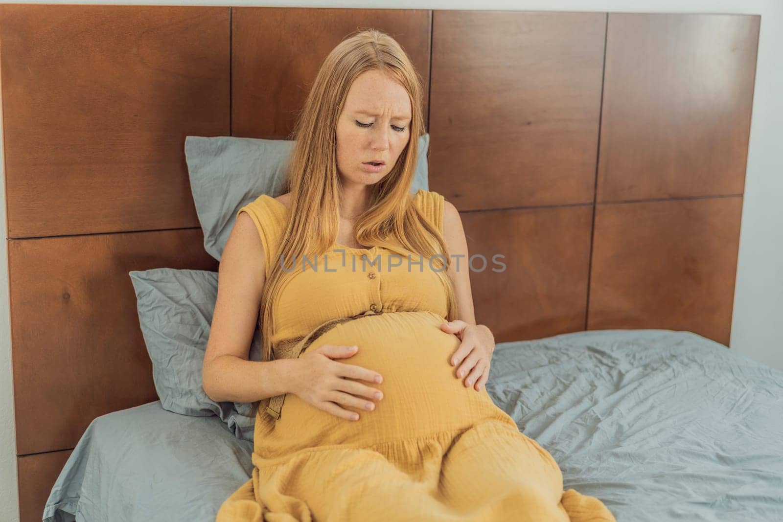 Expectant woman experiences discomfort, feeling unwell during pregnancy.