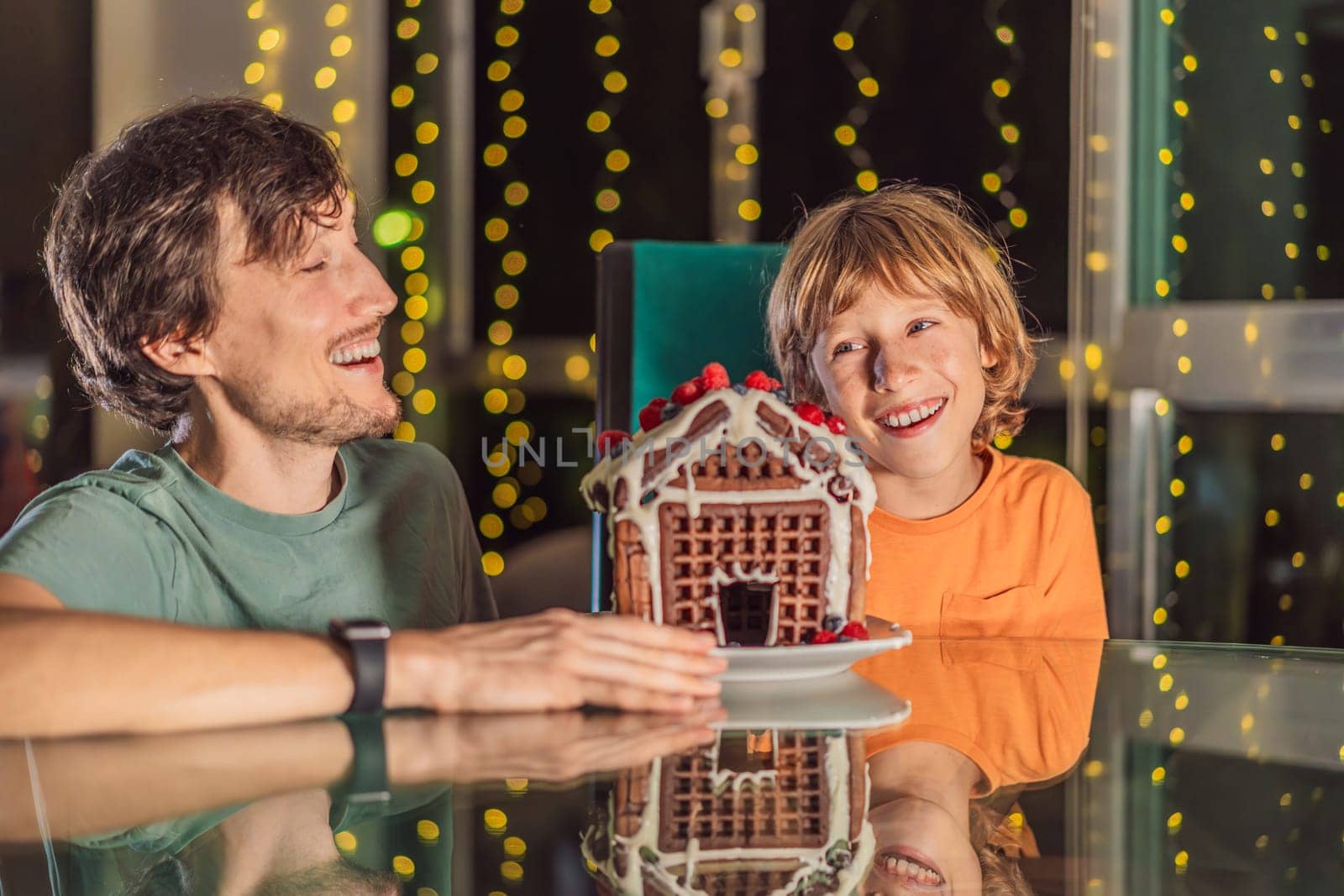 Savor unique moments as dad and son bite into an unconventional gingerbread house, adding a twist to Christmas traditions. A tasty blend of creativity and family joy.