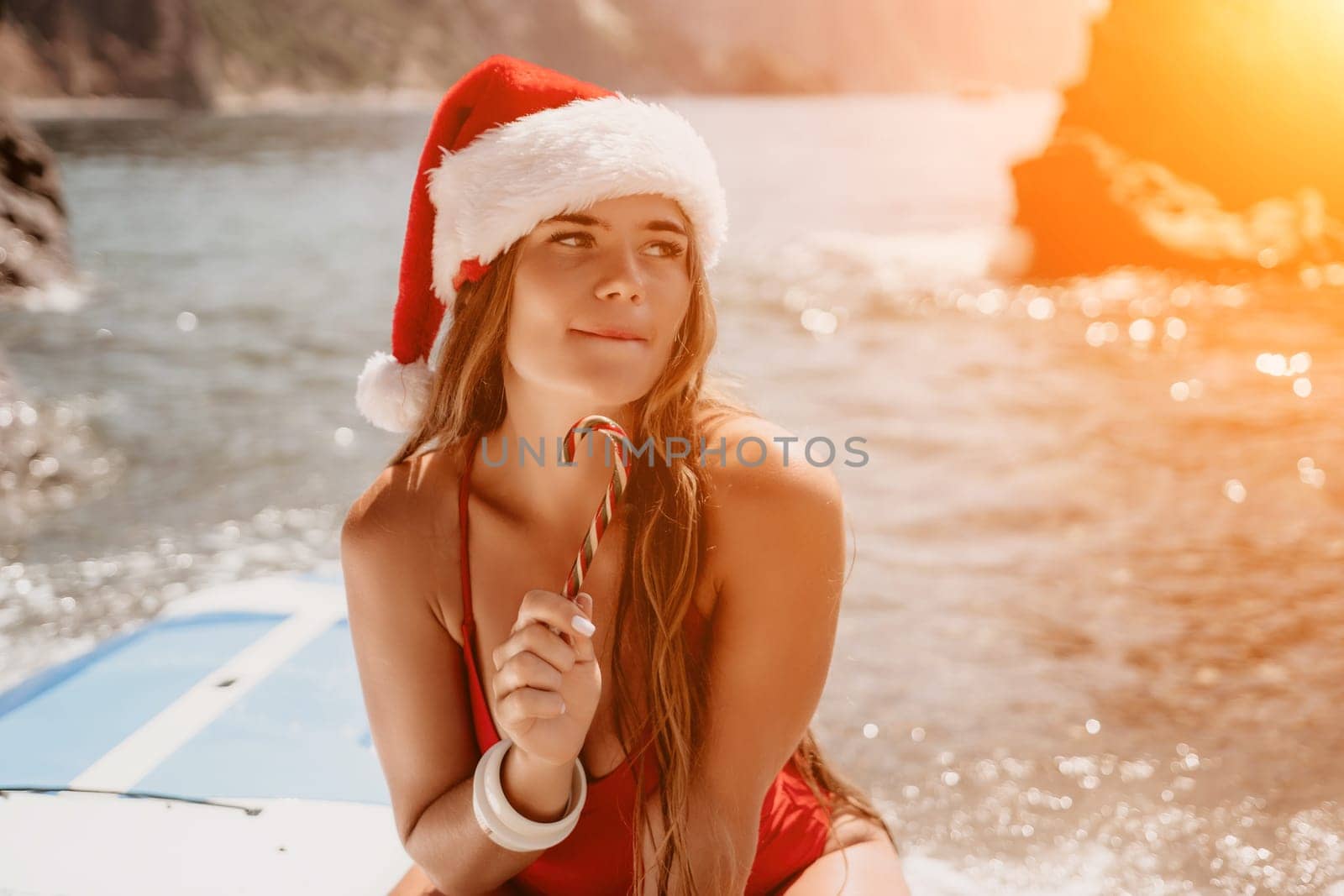 Woman travel sea. Happy tourist taking picture outdoors for memories. Woman traveler looks at the edge of the cliff on the sea bay of mountains, sharing travel adventure journey.