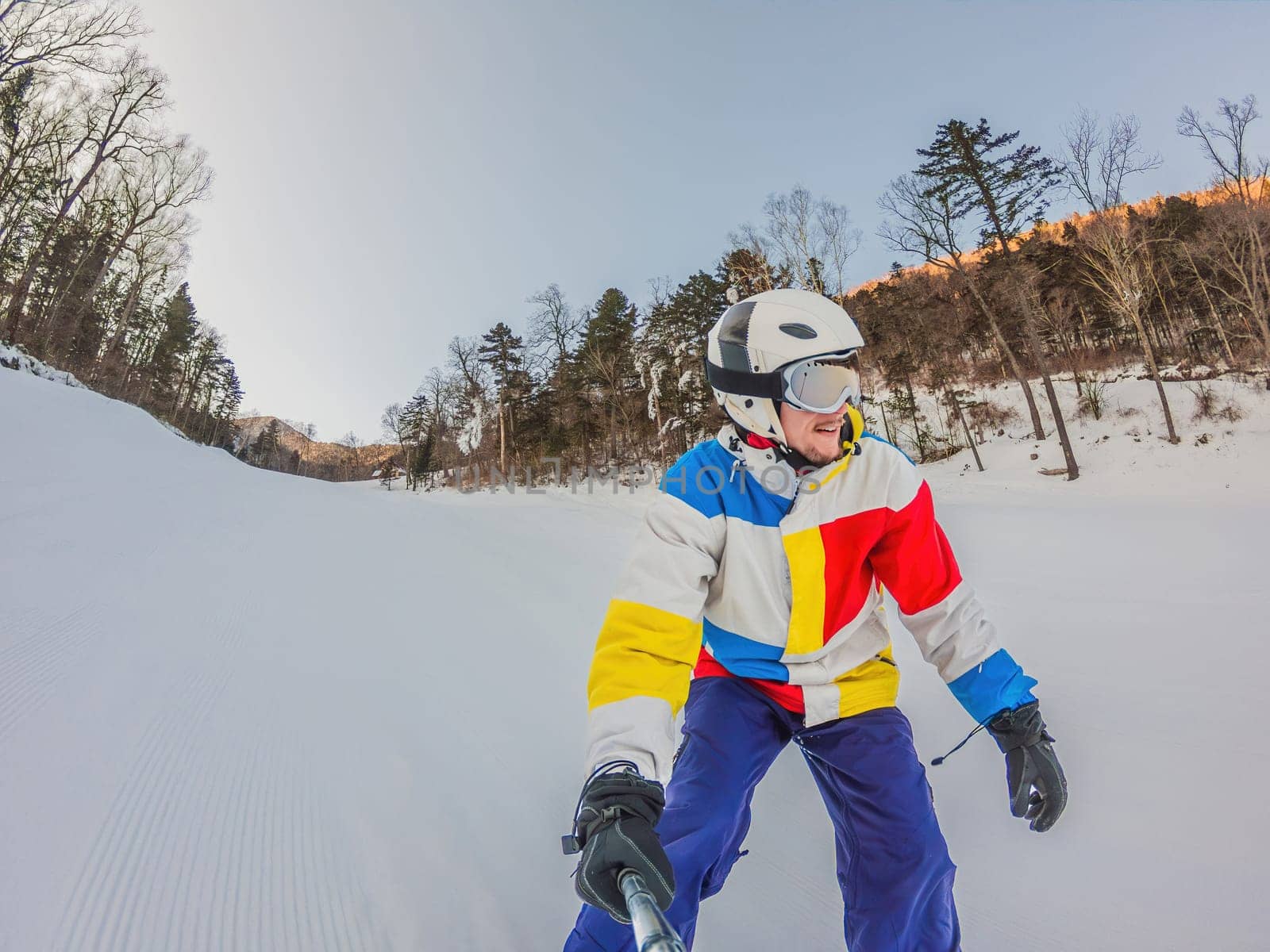 A daring man conquers snowy slopes with style, showcasing skill and thrill as he maneuvers on a snowboard, capturing the essence of winter adventure.