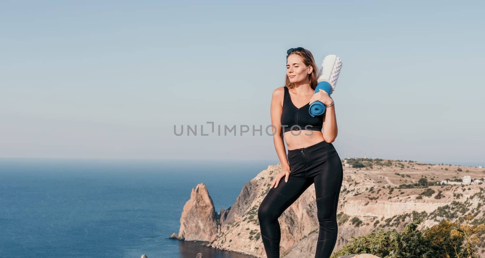 Fitness woman sea. Outdoor workout with fitness rubber bands in park over beach. Female fitness pilates yoga routine concept. Healthy lifestyle. Happy fit woman exercising with rubber band in park. by panophotograph