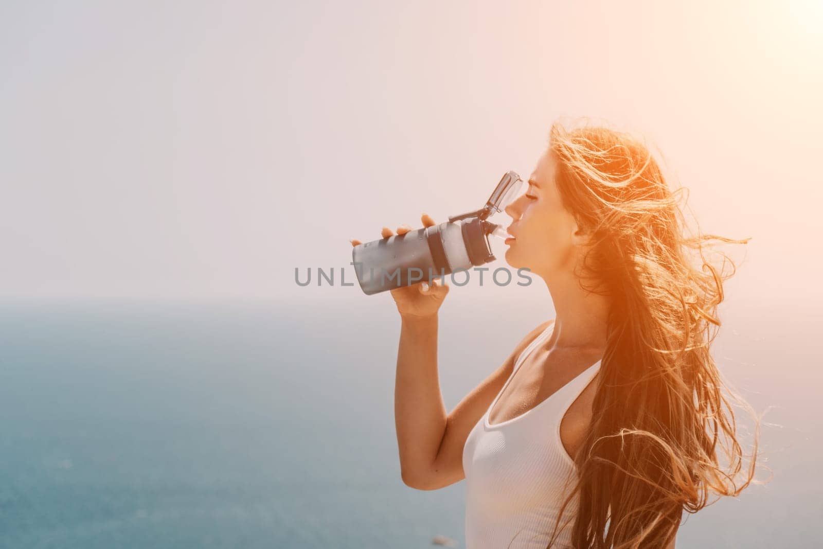 Woman summer travel sea. Happy tourist enjoy taking picture outdoors for memories. Woman traveler posing over sea bay surrounded by volcanic mountains, sharing travel adventure journey by panophotograph